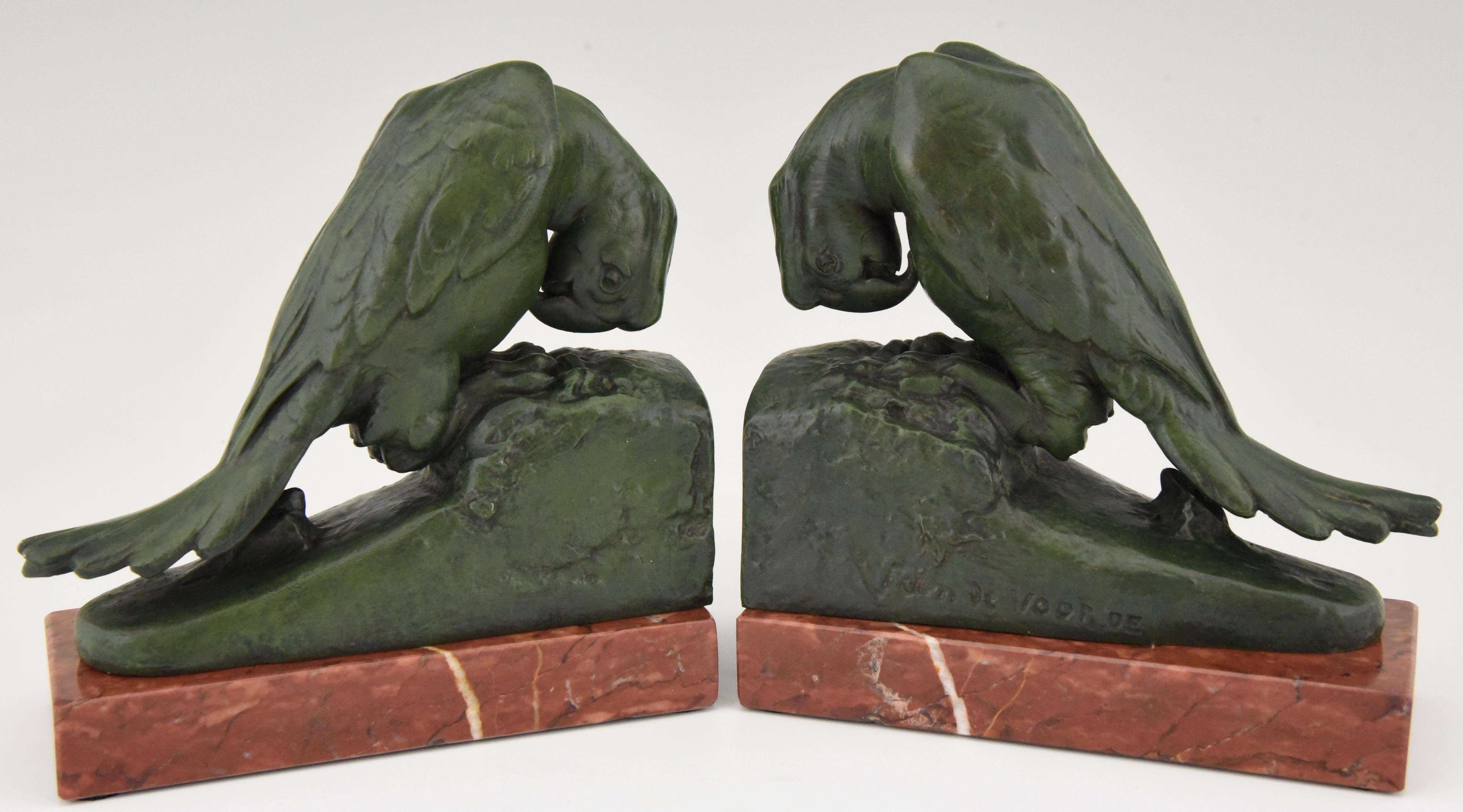 Parrot bookends by Georges Van De Voorde, a Belgian artist born in 1878 worked in France. The Art metal bokends have a lovely green patina and are mounted on a Belgian red marble base. Made in France circa 1930
Literature:
These bookends are