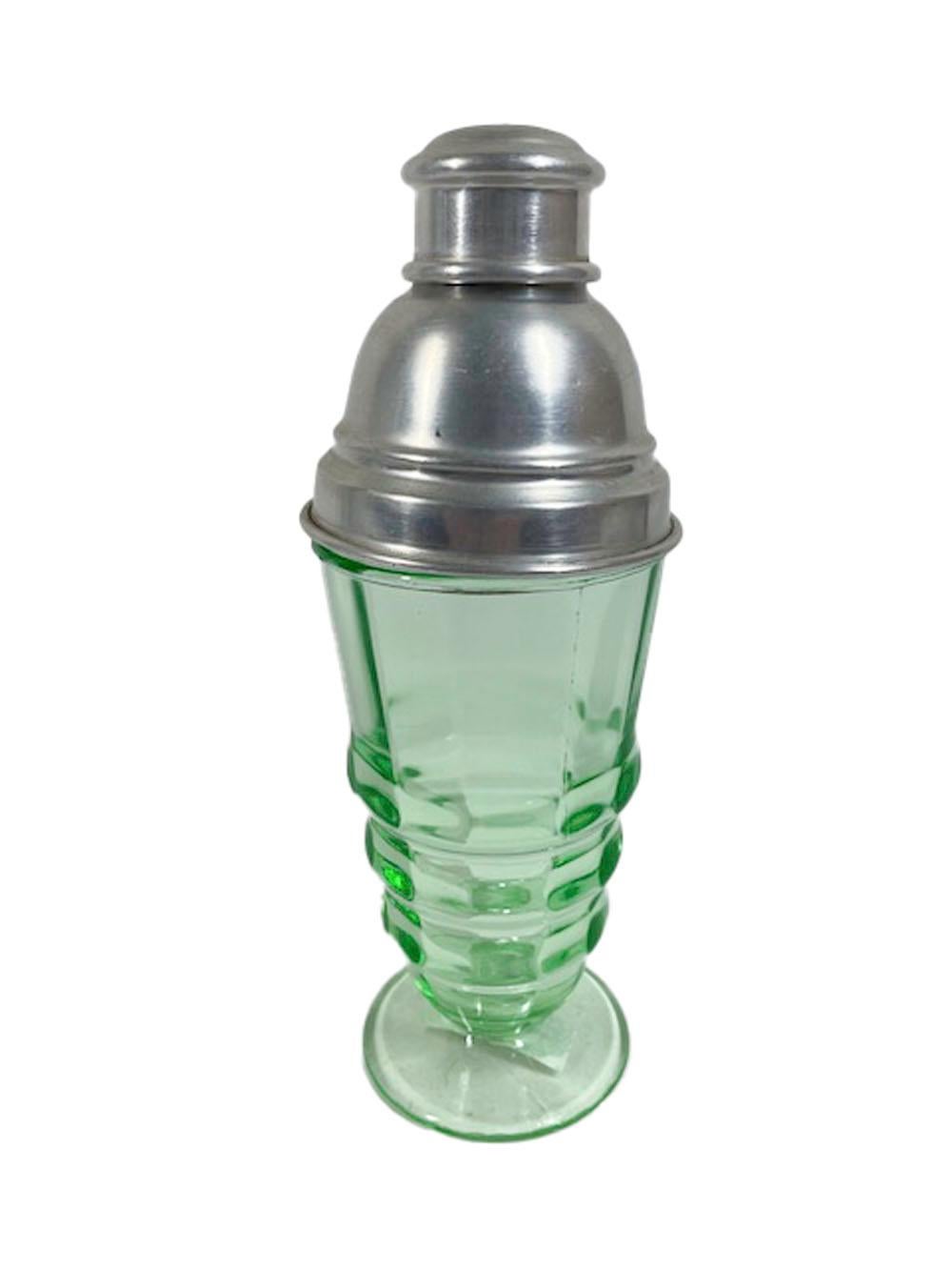 Pale green glass cocktail shaker in the 'Party Line' pattern by Paden City Glass having a panel-sided stepped body tapering to the base and on a circular foot. The high-domed center-pour lid with built-in reamer/strainer.