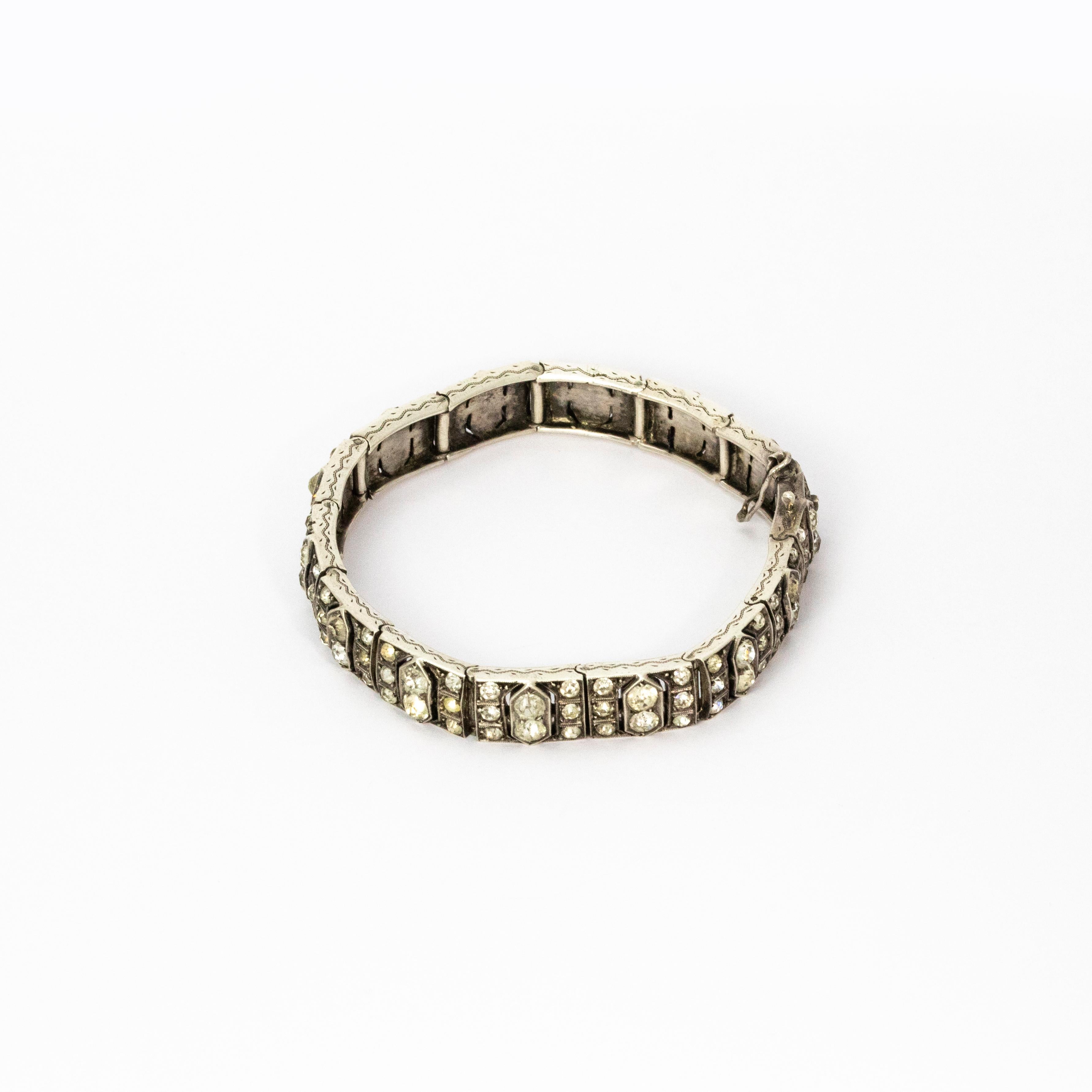A pretty Art Deco bracelet with fourteen segments set with paste and modelled in hallmarked 9 karat white gold. Great quality. 

Open Length: 18.5 cm 