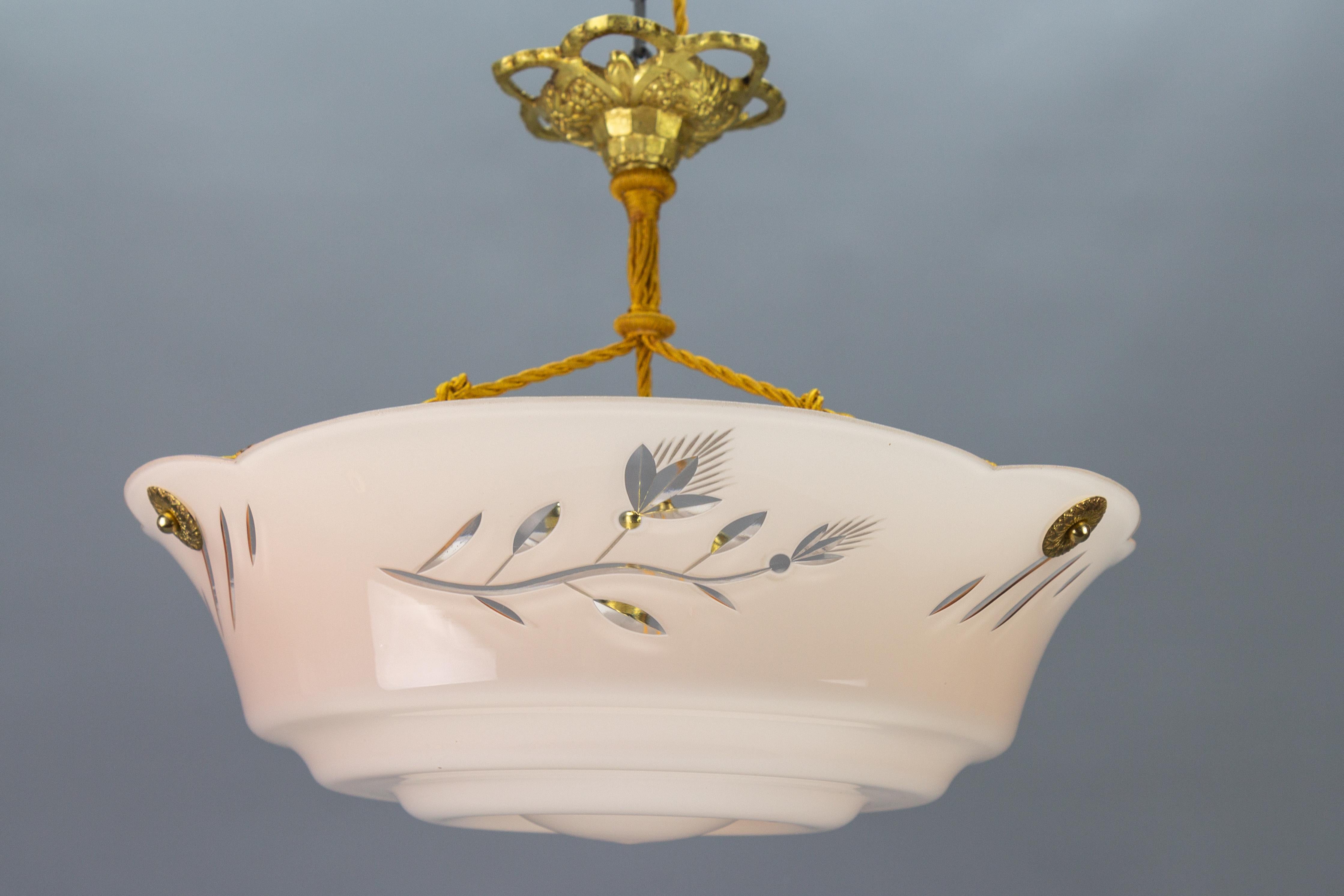 German Art Deco period pastel pink cut glass pendant light with flower motifs, the 1930s.
A wonderful pendant ceiling light fixture from circa the 1930s. The beautifully shaped glass bowl in pastel pink features a cut decoration of flowers and