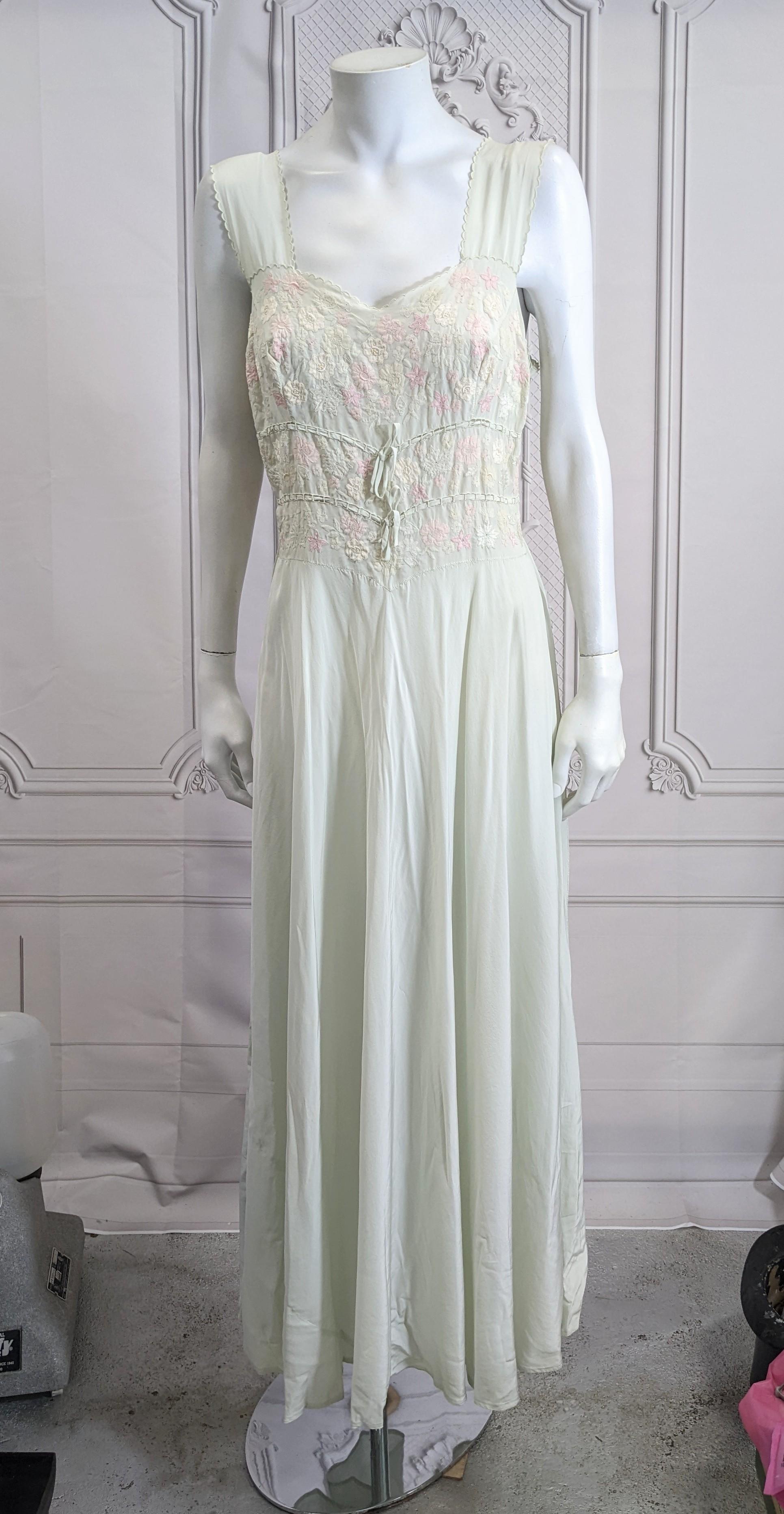 Art Deco Pastel Silk Crepe Floral Invisibly Embroidered Slip Gown. Bodice completely covered in pastel re-embroidered florals attached to a full skirt and sash. Pale celadon silk crepe with 2 ties along rib cage and wide back sash. Incredible hand