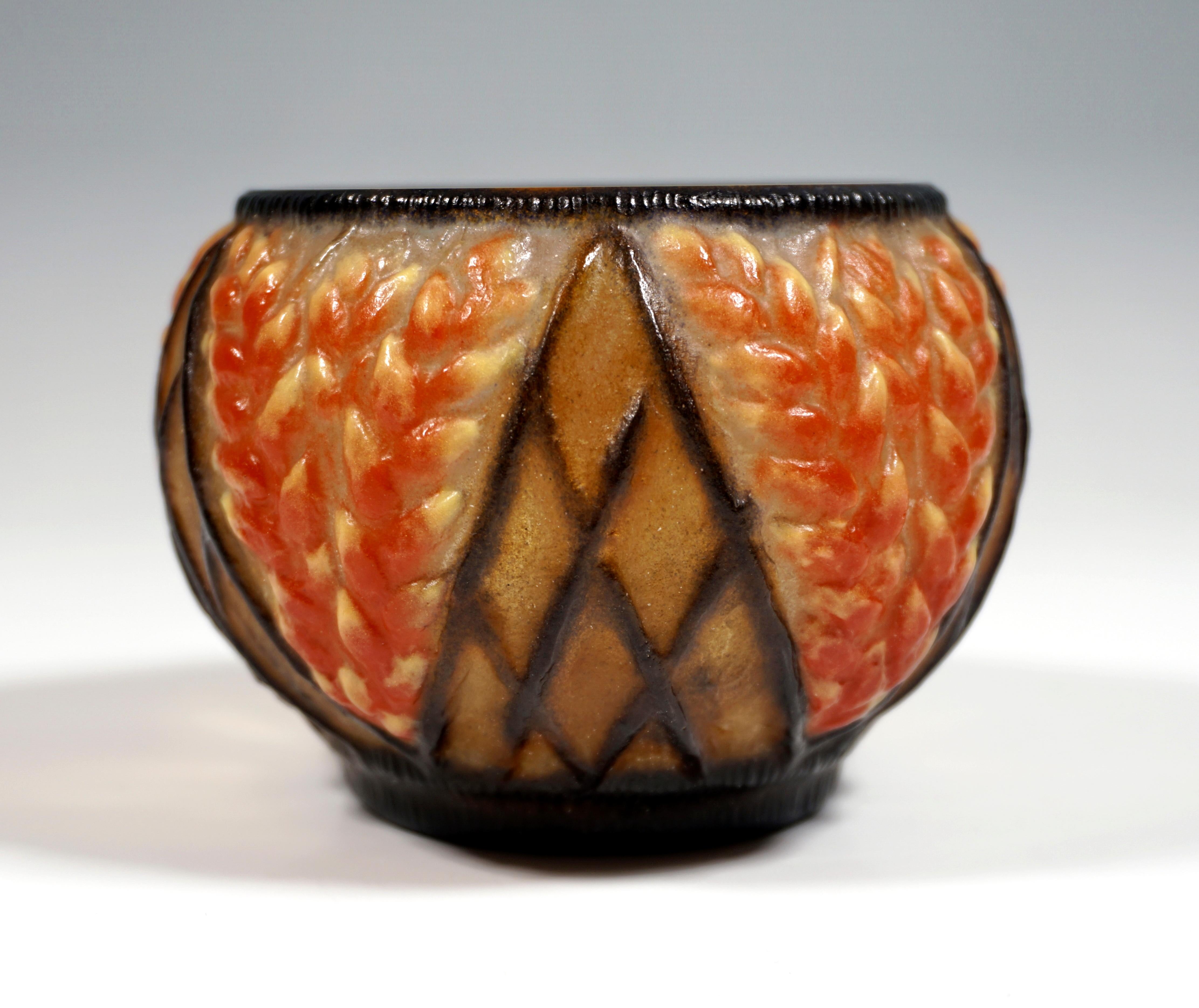 Bulbous bowl of colorless pâte de verre with colored powder inclusions in yellow, red & black, relief decoration with stylized ears of grain and geometric triangle and diamond pattern. Signed 'G. Argy-Rousseau' on the body, 'FRANCE' pressed on the
