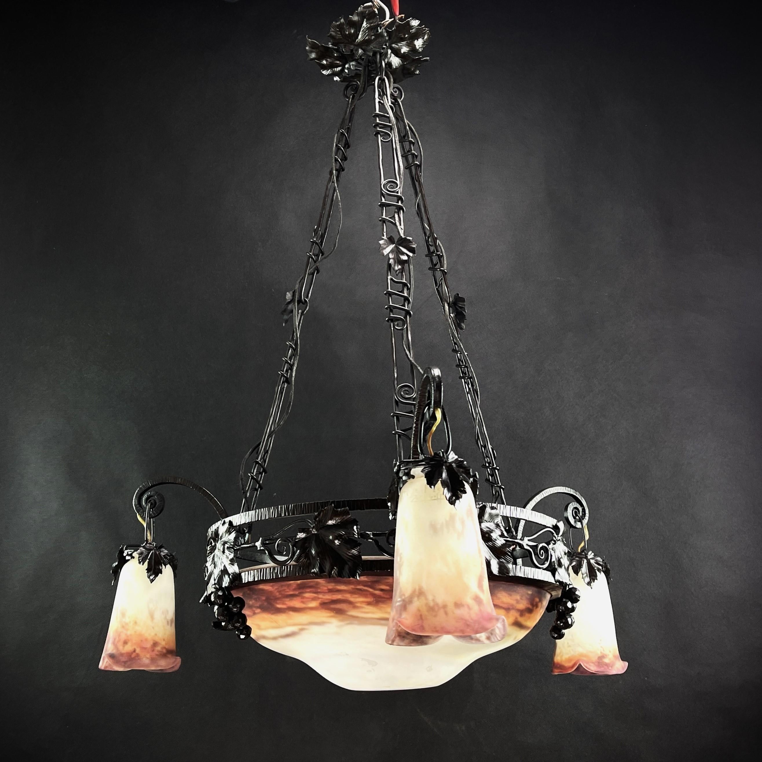 Art Deco chandelier by Muller Fréres - 1930s

This original pendant lamp captivates with its simple and matter-of-fact Art Deco design. The heavy lamp with its colorful Pate de Verre glas is signed and gives a very pleasant light. This ceiling