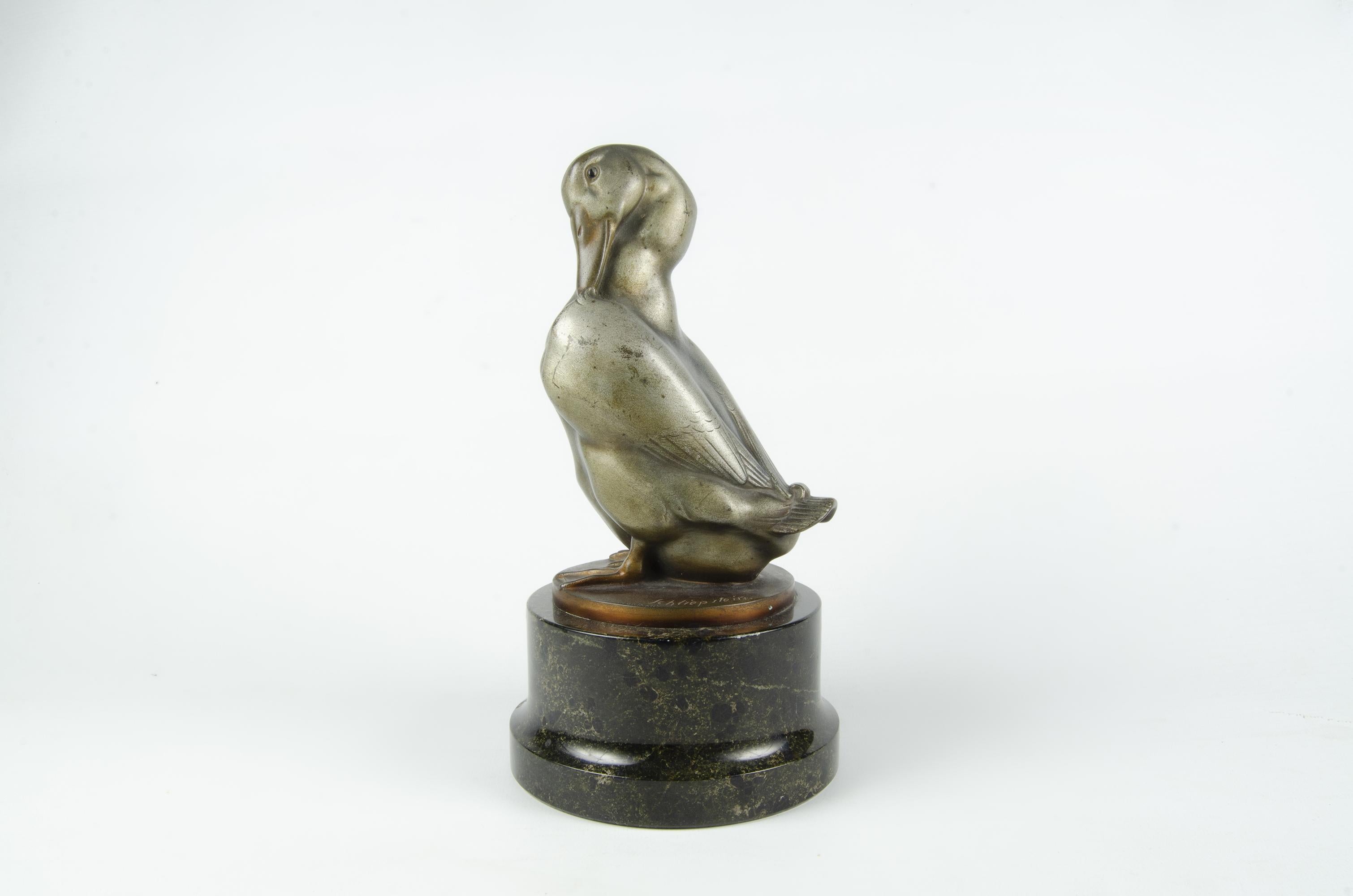 Early 20th century Art Déco patinated bronze sculpture of duck with marble base by Gerhard Schliepstein, Germany

By: Gerhard Schliepstein
Material: bronze, copper, tin, metal, stone, marble
Technique: cast, molded, patinated, polished,