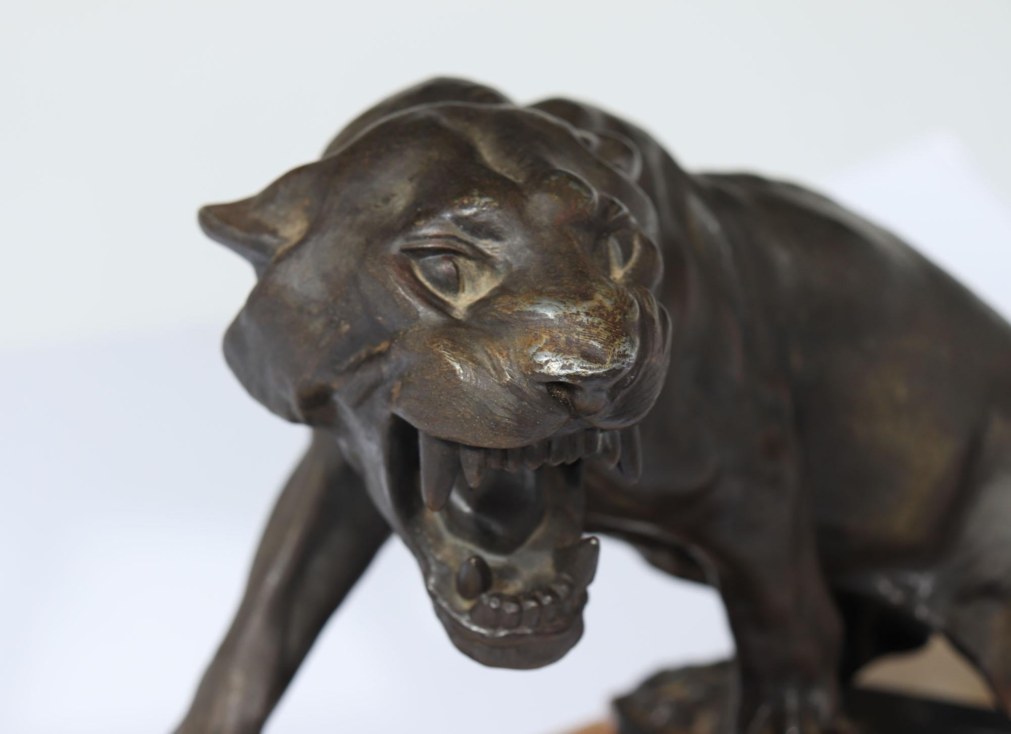 ART DECO PATINATED BRONZE TIGER 
A stunning patinated spelter sculpture of a fierce, roaring feline that embodies exceptional realism and expression. This masterpiece is expertly crafted to captivate the eye and evoke a sense of power and strength.