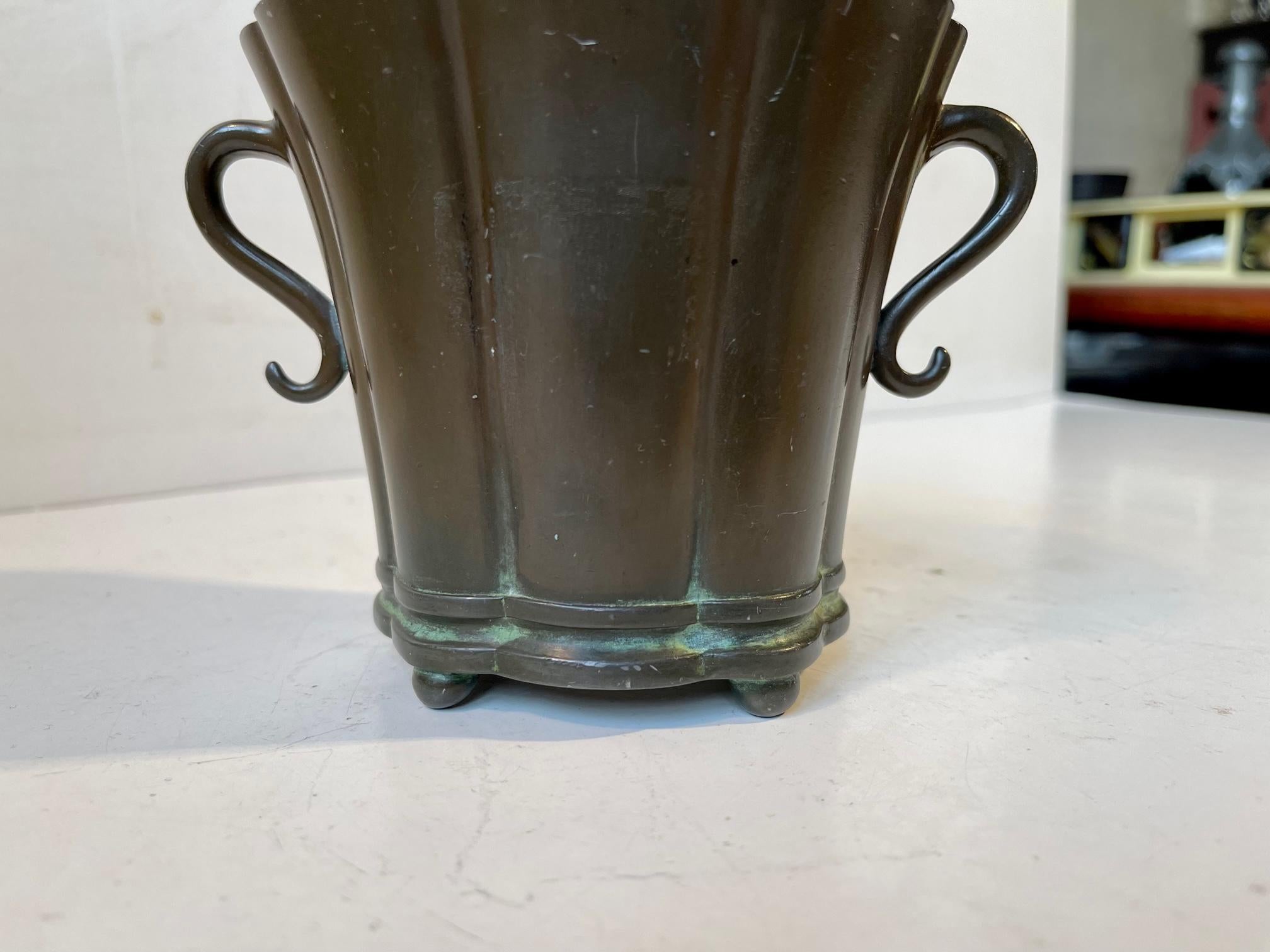 Small curvy disco-metal planter with a green patina. Distinct Art Deco styling. Designed and made by Just Andersen in Denmark circa 1930-40. Design number: D18. Disko-metal is Just Andersen own invention/alloy. Measurements: H: 10 cm, W: 11 cm