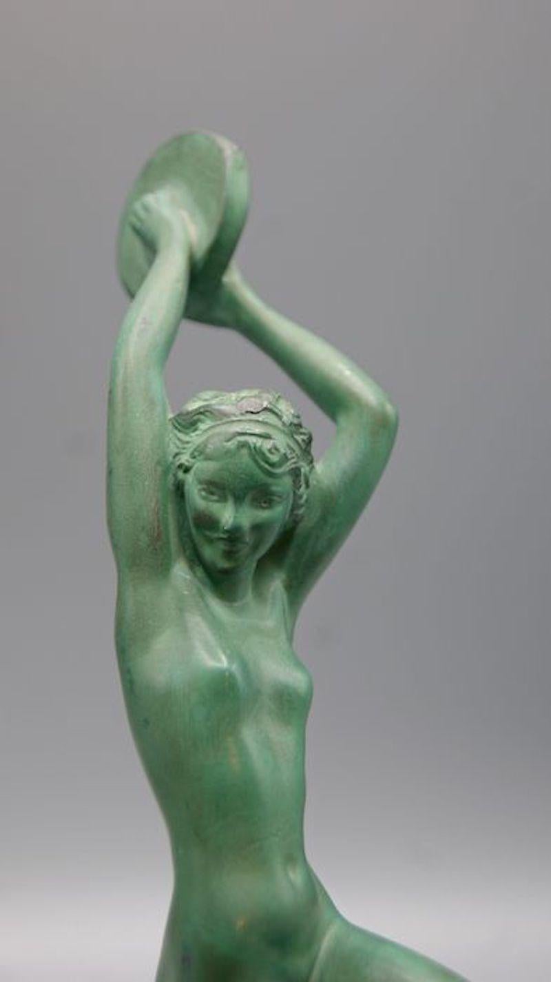 Art Deco patinated metal (blend of metals and bronze) sculpture, named Esmeralda, by the French female artist Raymonde Guerbe (1894–1995) pseudonym for Andrée Guerval.
Sculpture of a dancer Esmeralda with a tambourine. The piece is in great