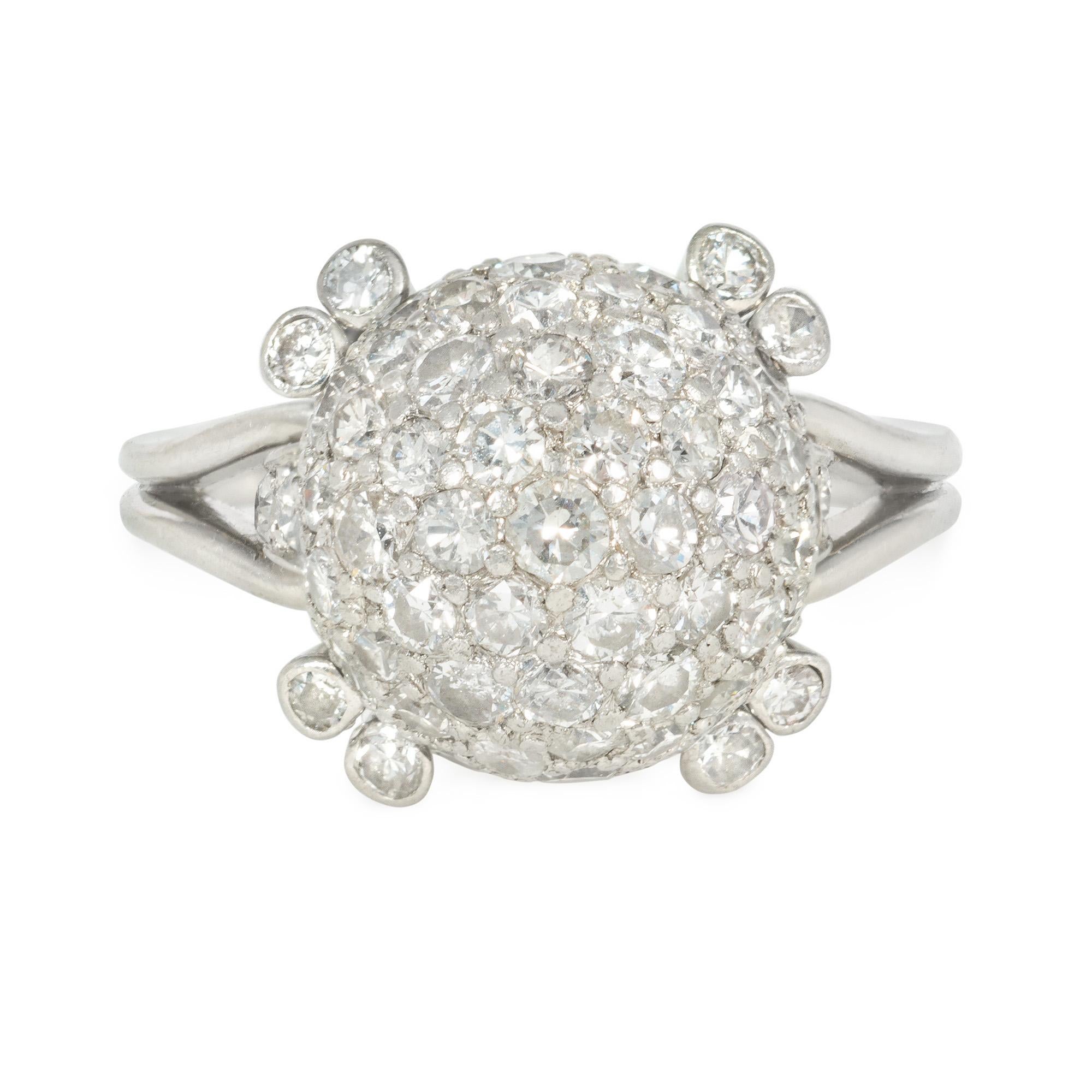 An Art Deco diamond ring centered by a pavé-set diamond sphere supported by pairs of collet-set diamonds at each corner, with diamond accented shoulders and a double-looped band, in platinum.  Atw 1.50 cts.  Diameter of diamond ball approximately