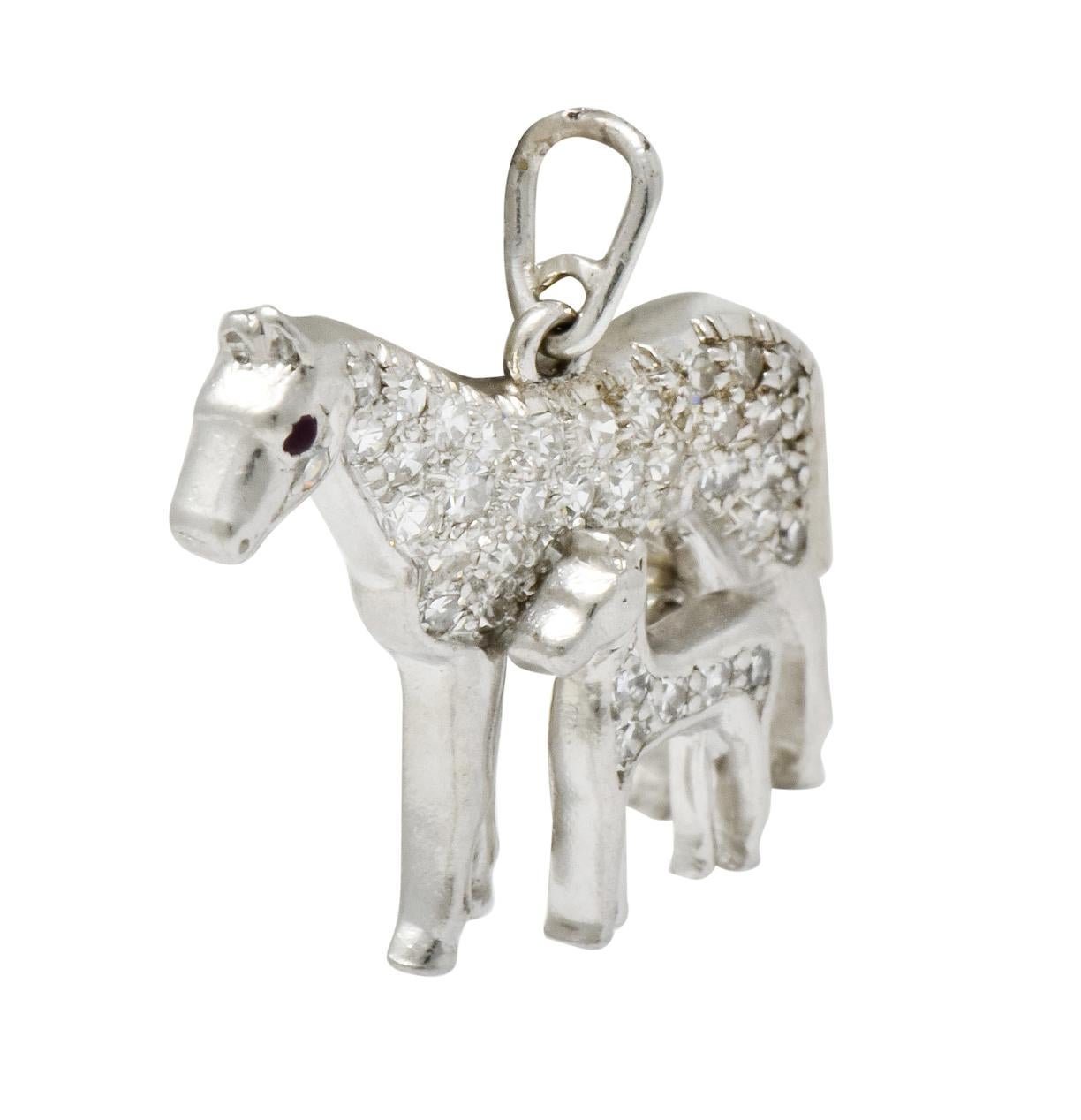 Charm is designed as a mother horse standing side-by-side with her foal

Each horse is pavé set throughout with single cut diamonds weighing approximately 0.45 carat total, eye-clean and white

Completed by round ruby cabochon eye accent and