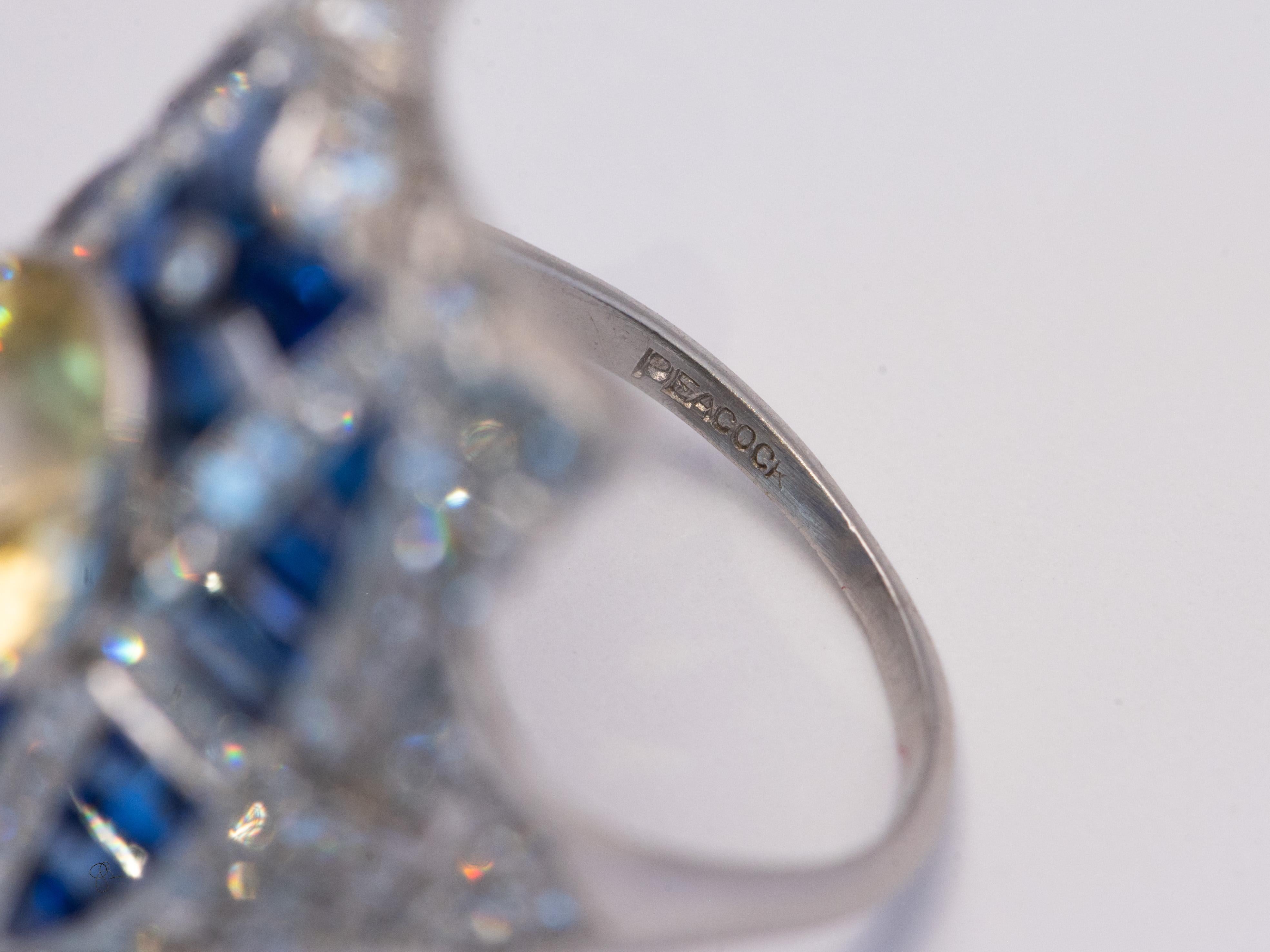 This piece belongs in a set with the matching brooch which is also posted here on 1st Dibs please see our store. 

Fashioned in 9.3 grams of Platinum
8mm Unheated Yellow Ceylon Sapphire estimated 3.5 carats.
Channel set fine blue sapphires estimated