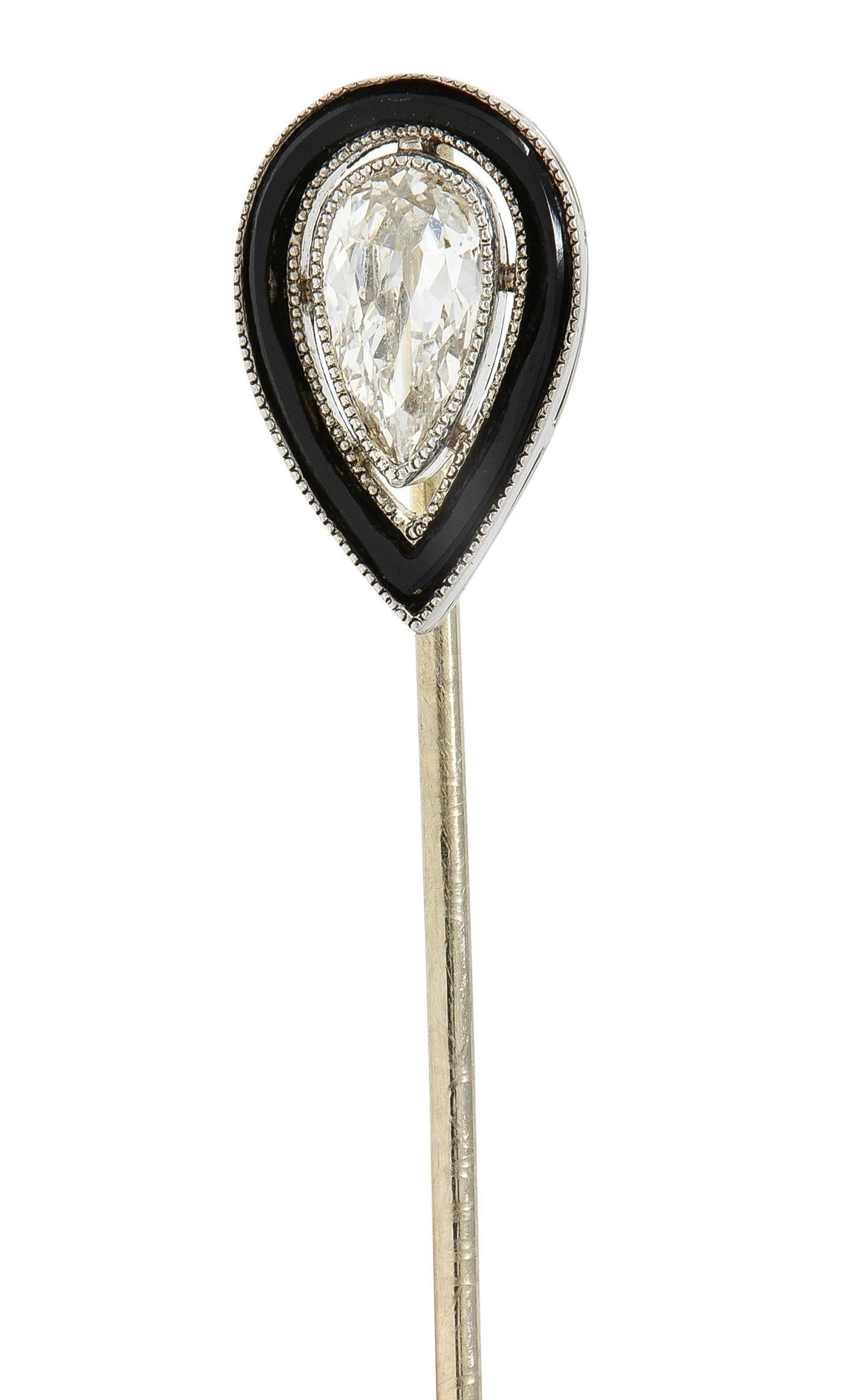 Centering a pear cut diamond weighing approximately 0.30 carat - K color with SI1 clarity
Set in miligrain detail bezel with pierced floating halo surround 
Inlaid with onyx - opaque glossy black 
Completed by pinstem 
Head tested as
