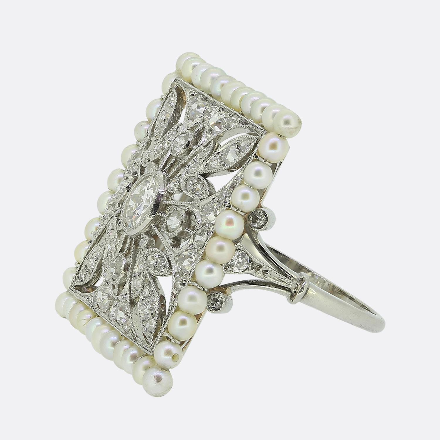 Here we have an outstanding dress ring crafted at a time when the Art Deco style was at the height of design. The tone of piece is set by intricate filigree work which acts as the backdrop to multiple foliated motifs playing host to a vast array of