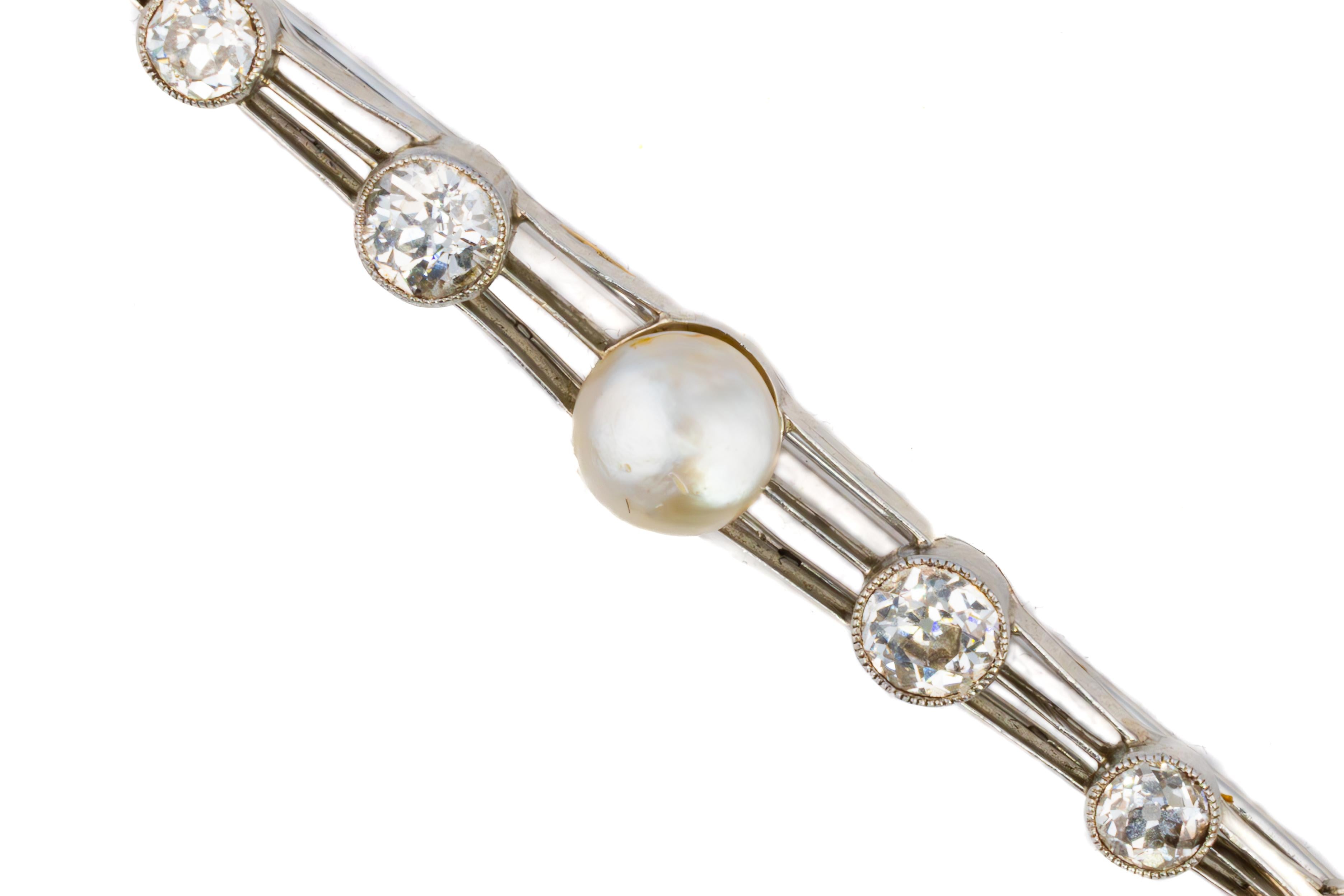 Art Deco Pearl and Diamond Platinum Bar Brooch

Description:
This graceful Art Deco brooch features a refined composition of diamonds and pearls arranged along a platinum bar, creating an elegant line of luminous symmetry. At its center is a softly
