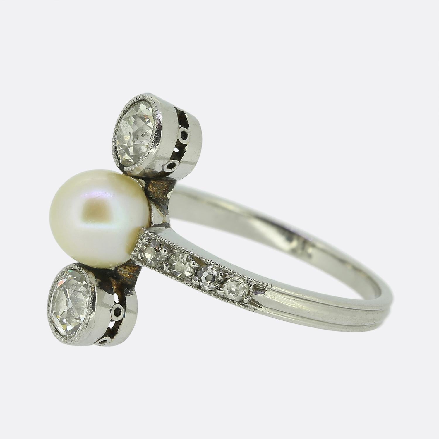 Here we have a gorgeous pearl and diamond three-stone ring crafted during the pinnacle of the Art Deco movement. A single slightly off-round pearl sits proud at the centre of the face and is accompanied above and below by a round faceted old
