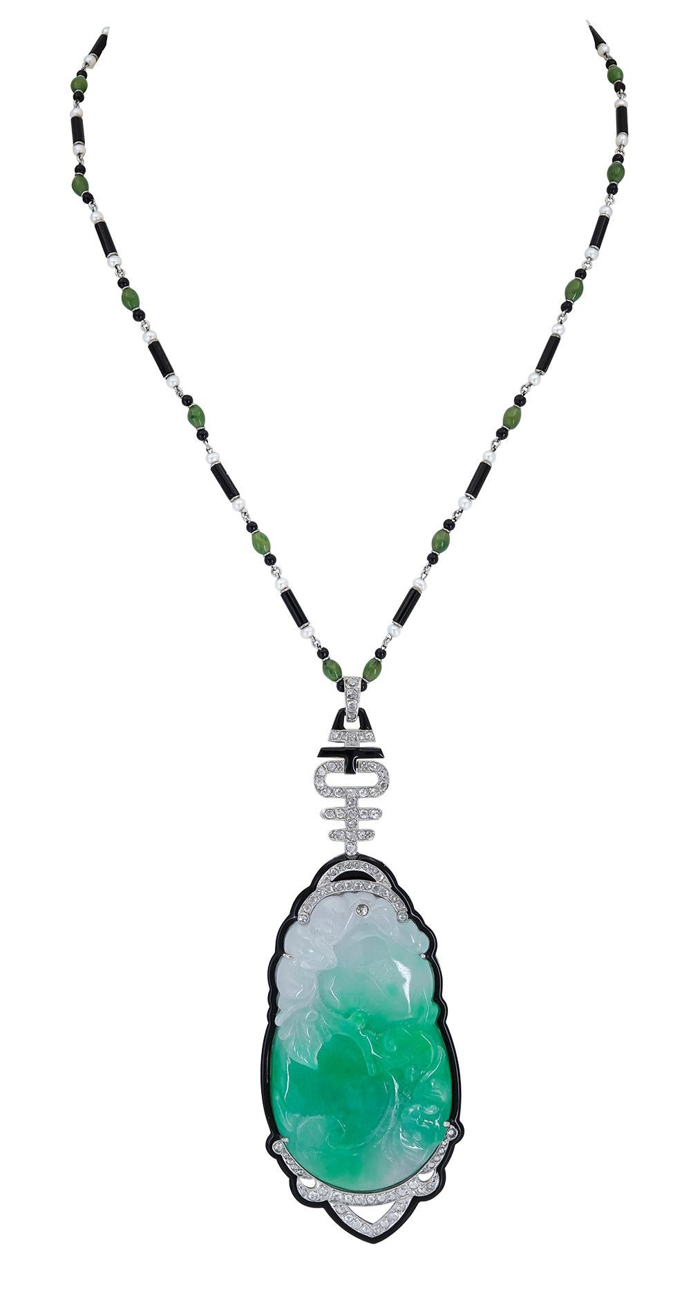 Features a hand-carved jade pendant set in an onyx and diamond surround. Suspended on a beautiful chain made of small pearls, jade and onyx. A magnificent piece of jewelry.

Pendant Dimensions: 4.00 in x 1.375 in
Chain Length: 17.75 in
Chain