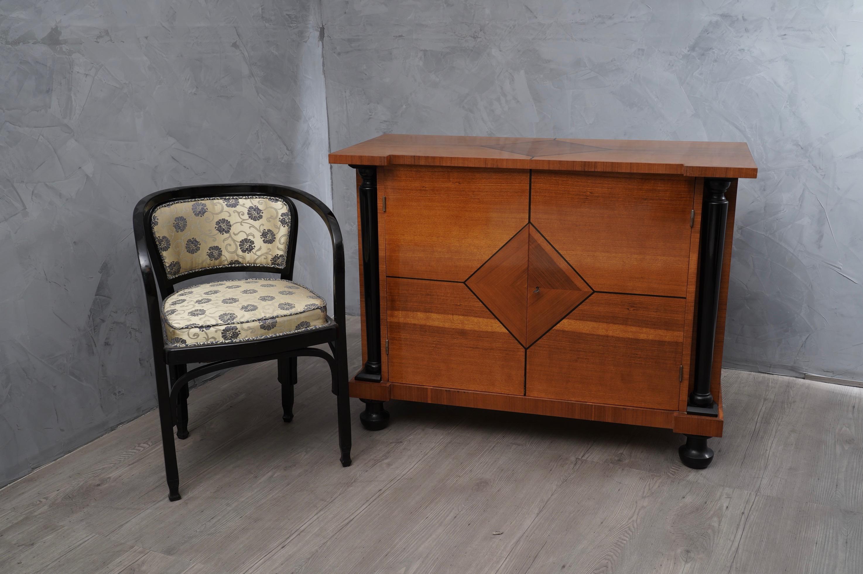 A beautiful patina characterizes the pear wood grain, enhanced by columns and feet lacquered in black shellac. 

Art Deco Austrian sideboard, all veneered in pear wood, with special threads in ebonized wood in the front part. Its color is very warm.