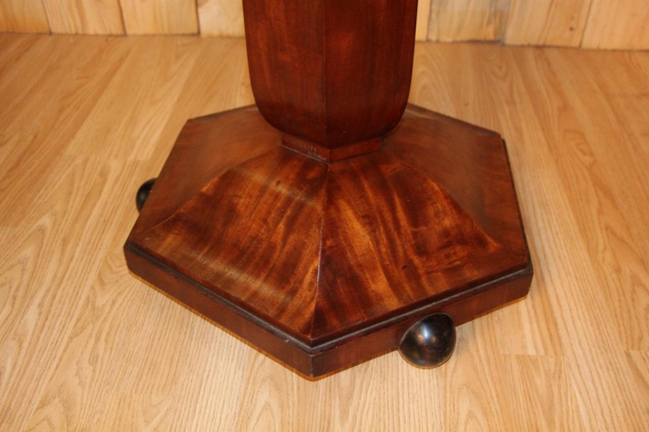 Pedestal table from the Art Deco period signed by auguste Vallin a nancy black marble top and mahogany veneer body minimal scratches from use on the veneer in very good condition.