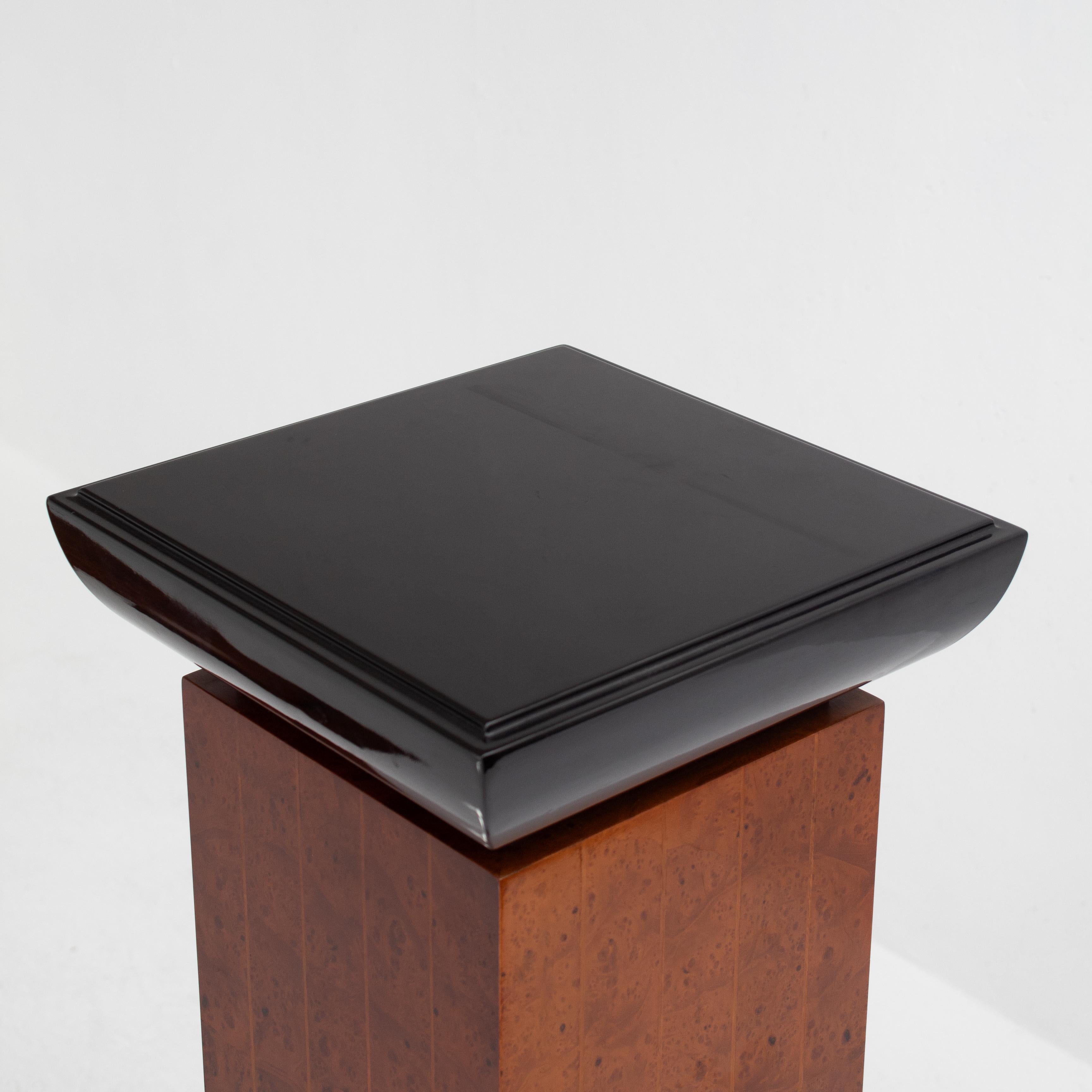 These Art Deco pedestals stand as refined statements of design. Their tall and slender form gives presence without overwhelming the space. The black tops create a bold contrast with the warm brown bases, adding depth and balance.
The geometric lines