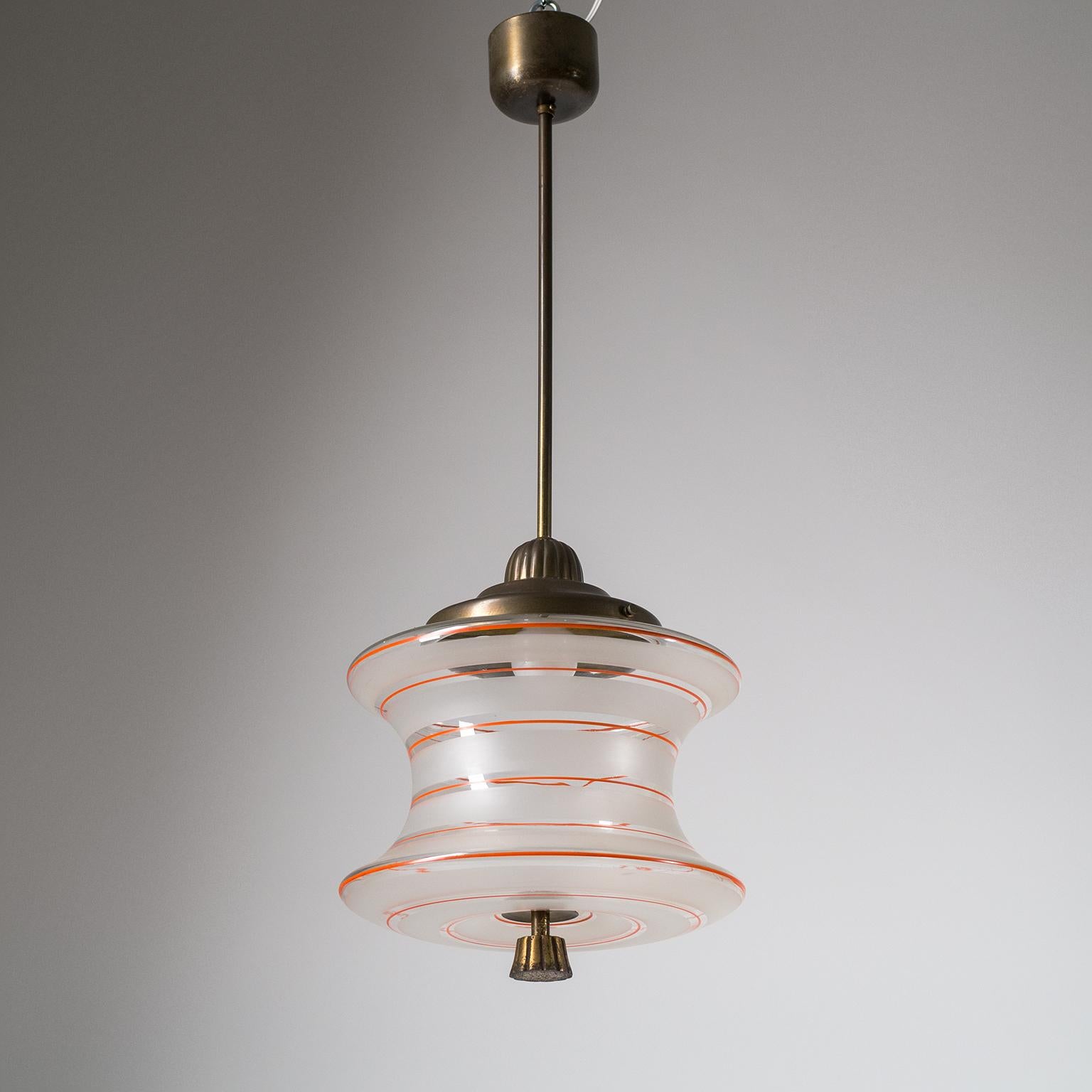 Unusually shaped glass pendant or lantern from the 1930s. The concave shaped blown glass diffuser has broad etched stripes with intermittent hand painted thin red lines. The hardware is brass with the bottom finial in brass plated steel. Fine