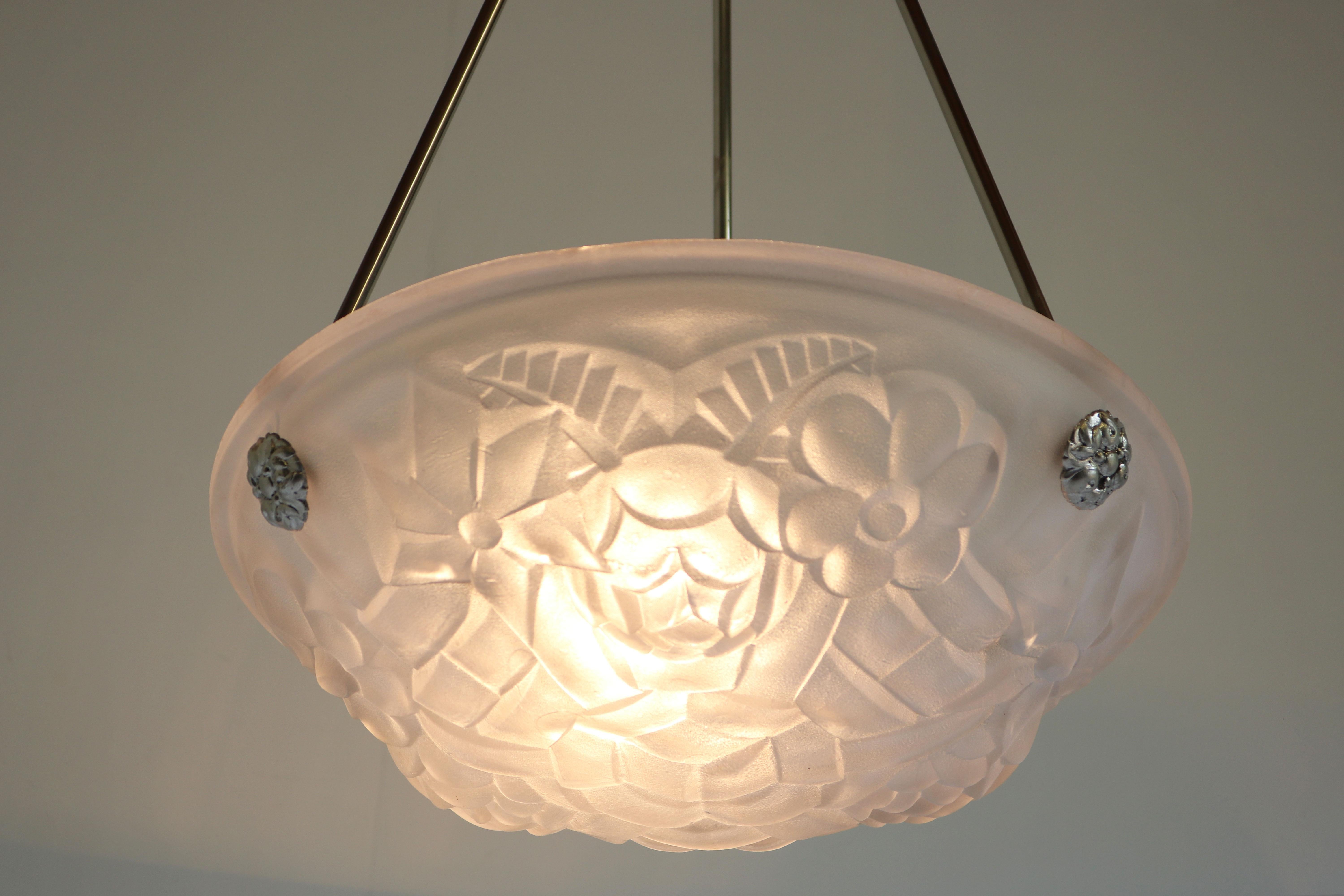 Gorgeous & timeless! This French Art Deco pendant by David Gueron Degue 1930. 
Marvelous white frosted glass shade with floral Art Deco motives. 
The chandelier comes with the original suspension in silver. The canopy has an amazing open floral