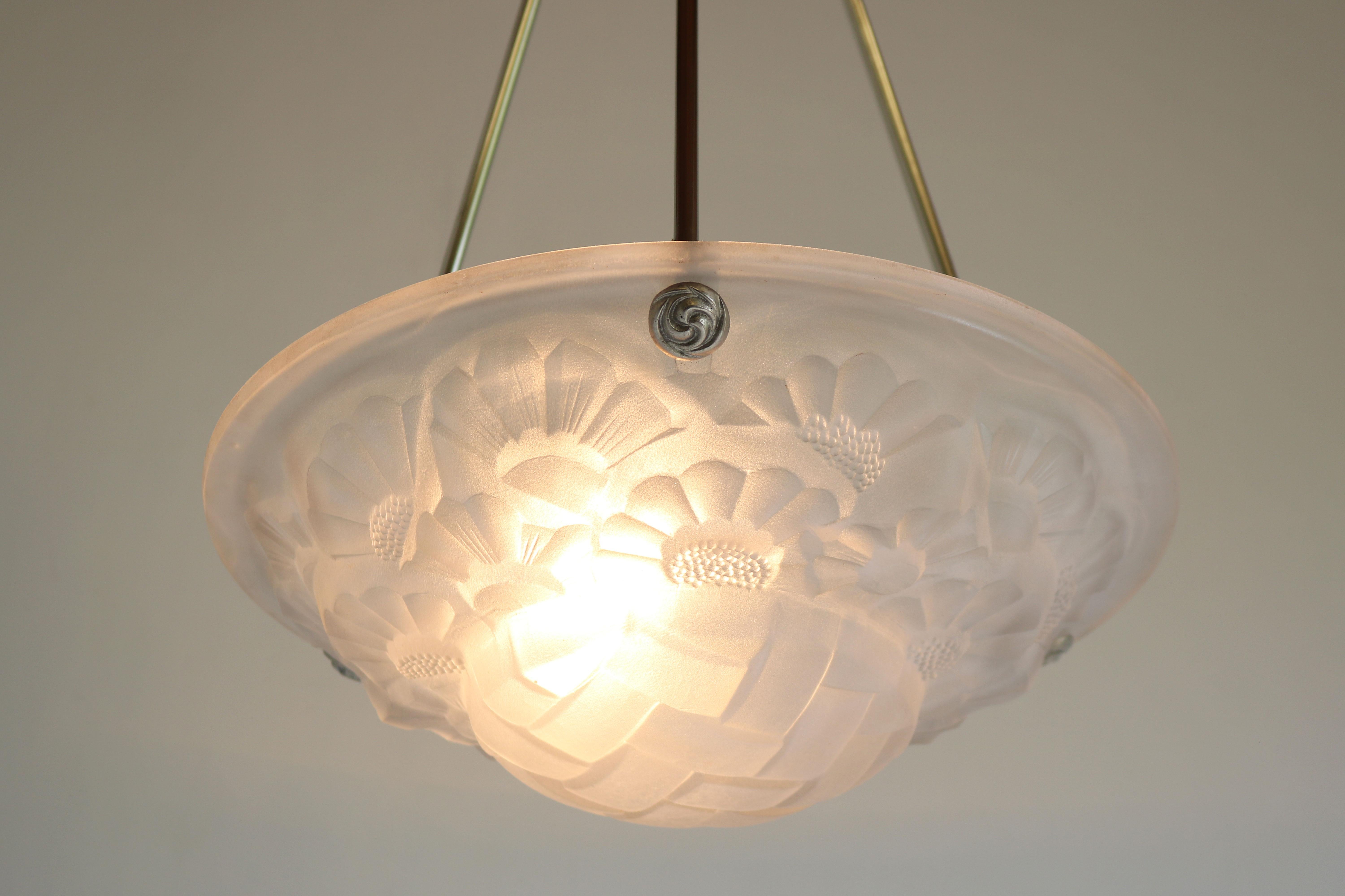 Gorgeous & timeless! This French Art Deco pendant by David Gueron Degue 1930.
Marvelous white frosted glass shade with floral Art Deco motives. 
The chandelier comes with the original suspension in silver with Art Deco decorations. 
Simply