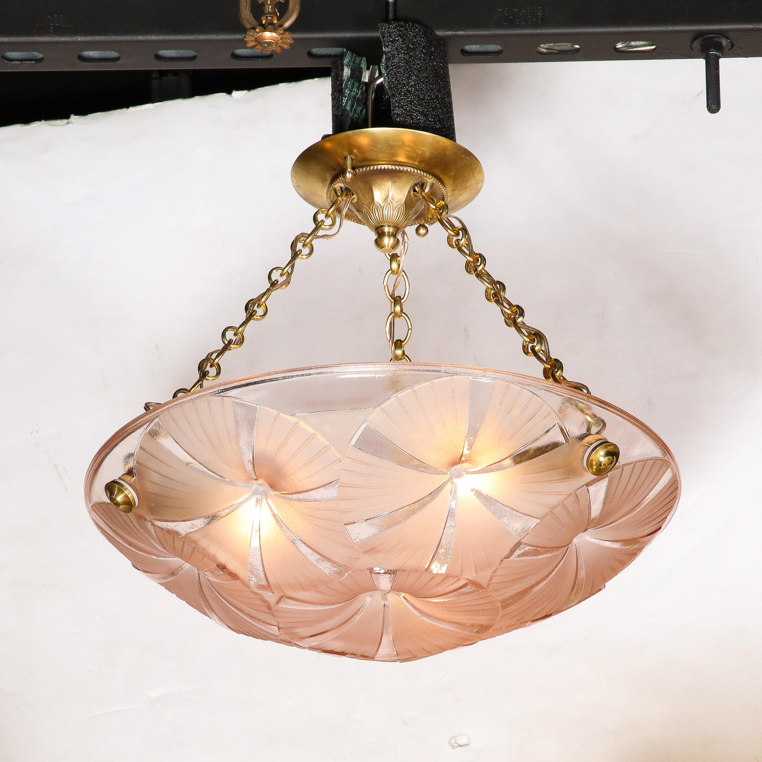 This alluring and materially exquisite Art Deco Pendant Chandelier in Molded & Frosted Rose Glass is signed Degue and originates from France, Circa 1930. Features a single rose hued molded glass shade with abstracted circular geometric motifs