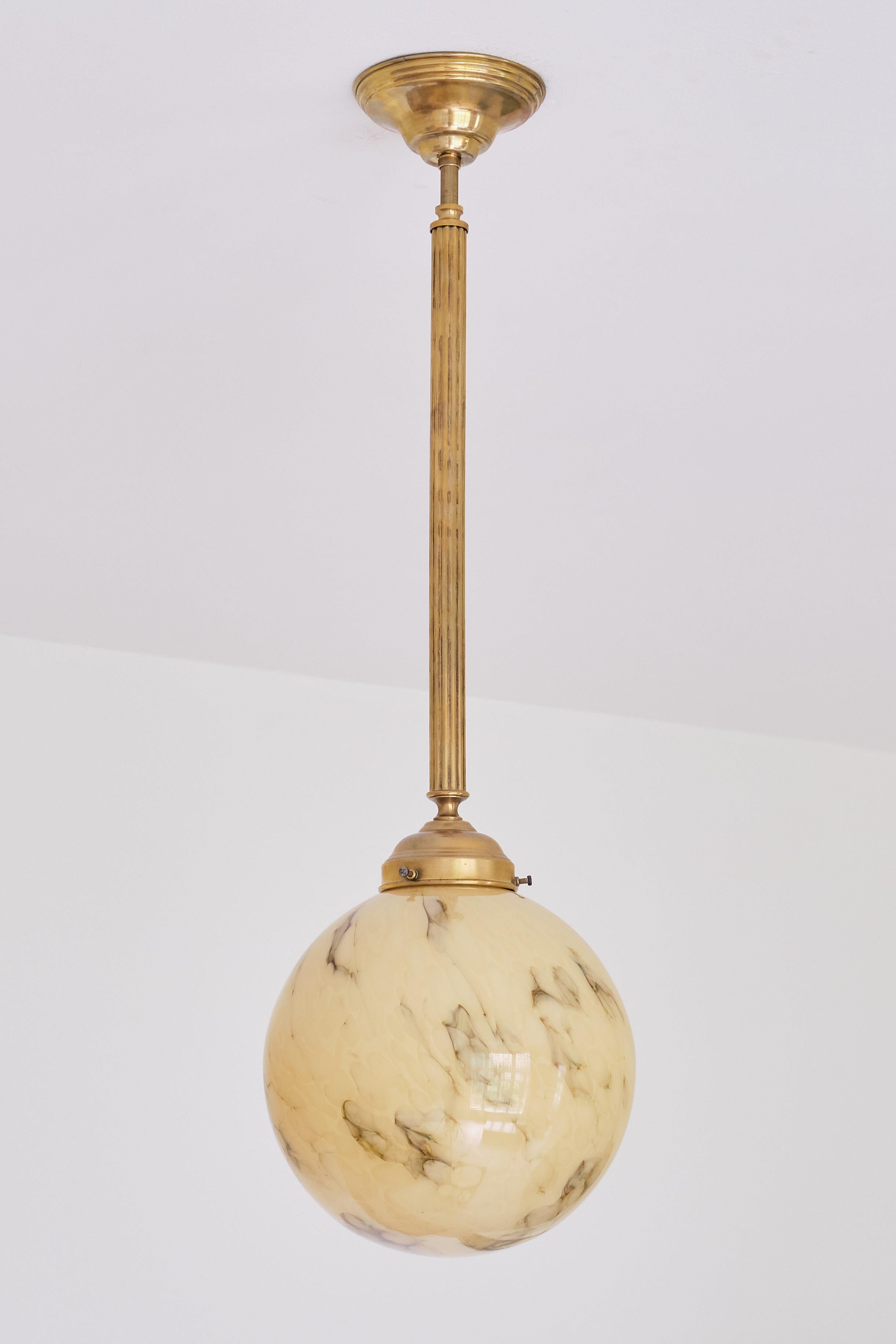 This striking pendant light was produced in the Netherlands in the late 1940s. 
The lamp on offer here was installed in the entrance lobby of the renowned De La Mar Theatre in Amsterdam. The entire interior of the theatre was designed by the