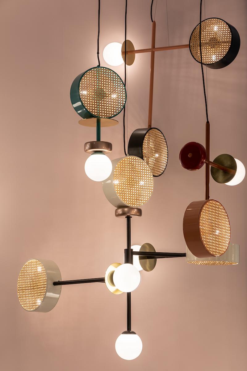 A perfect suspension of round shapes, rattan mesh and brass details intertwined with delicate and frosted glass globes, Monaco III is a contemporary Art Deco inspired Pendant. 
The structure and the cylinders are finished in a smooth, homogeneous