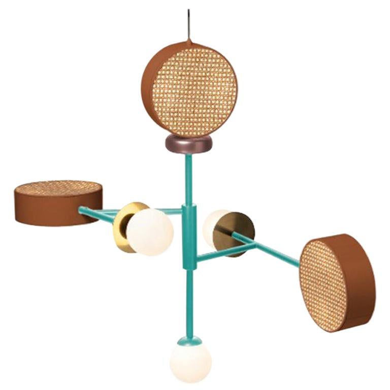 Monaco is a perfect suspension of round shapes, rattan mesh, wooden detail and brass details intertwined with delicate and frosted glass globes. 
The structure and the cylinders are finished in a smooth, homogeneous powder coating layer. The brass