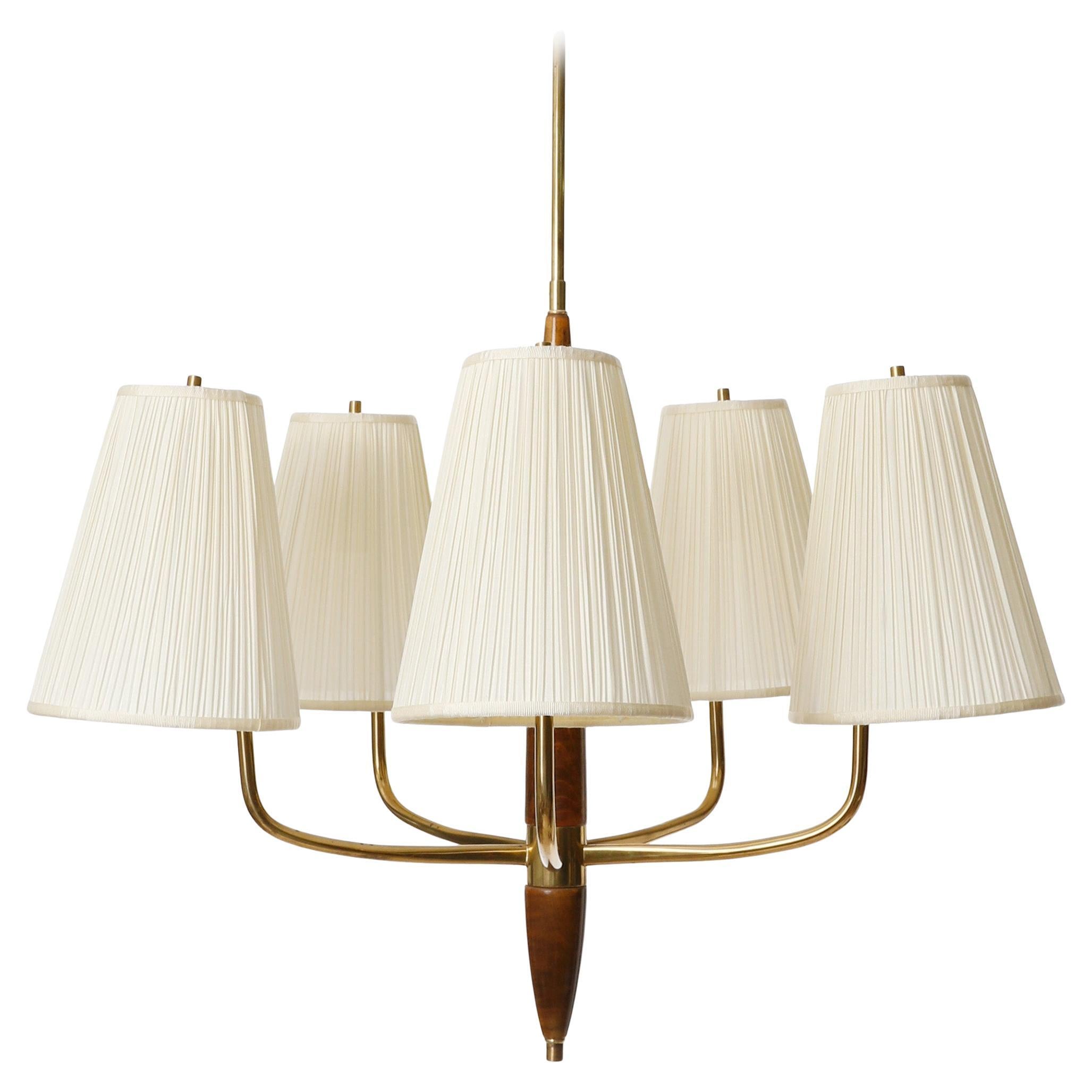 A fantastic five arm pendant lamp made of stained wood and brass with cream colored pleated fabric shades attributed to J.T. Kalmar and Josef Frank, manufactured in Austria in 1930s.
In the mid-1920s, Josef Frank and Oskar Wlach founded the