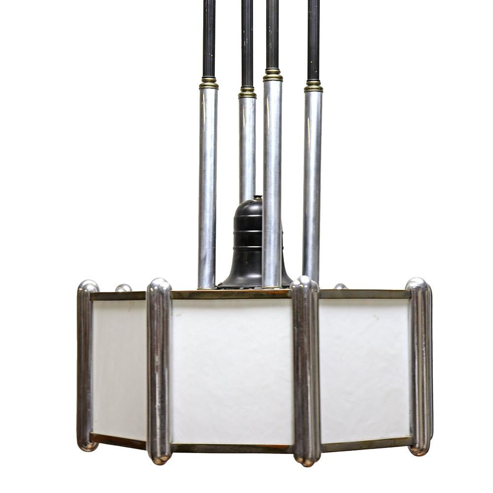 This pendant fixture is an Art Deco powerhouse. We love how the chrome accents contrast with the sleek black posts and white slag glass. If you are seeking early 20th-century statement lighting, this one is an absolute show stopper.