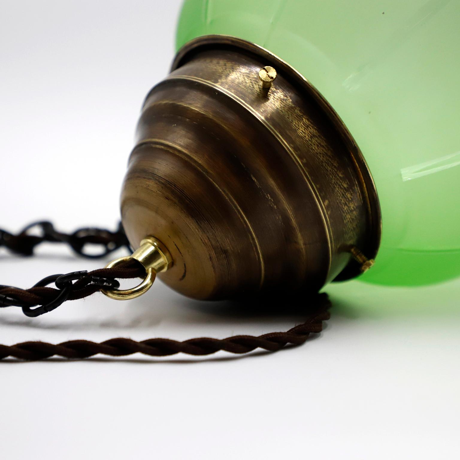 Circa 1930. We offer this Art Deco Pendant Light in Rare Green Opal Glass and Brass, Absolutely a very rare and difficult to find piece due to its beautiful color and materials. 
All electrical wiring has been changed for its proper functioning.