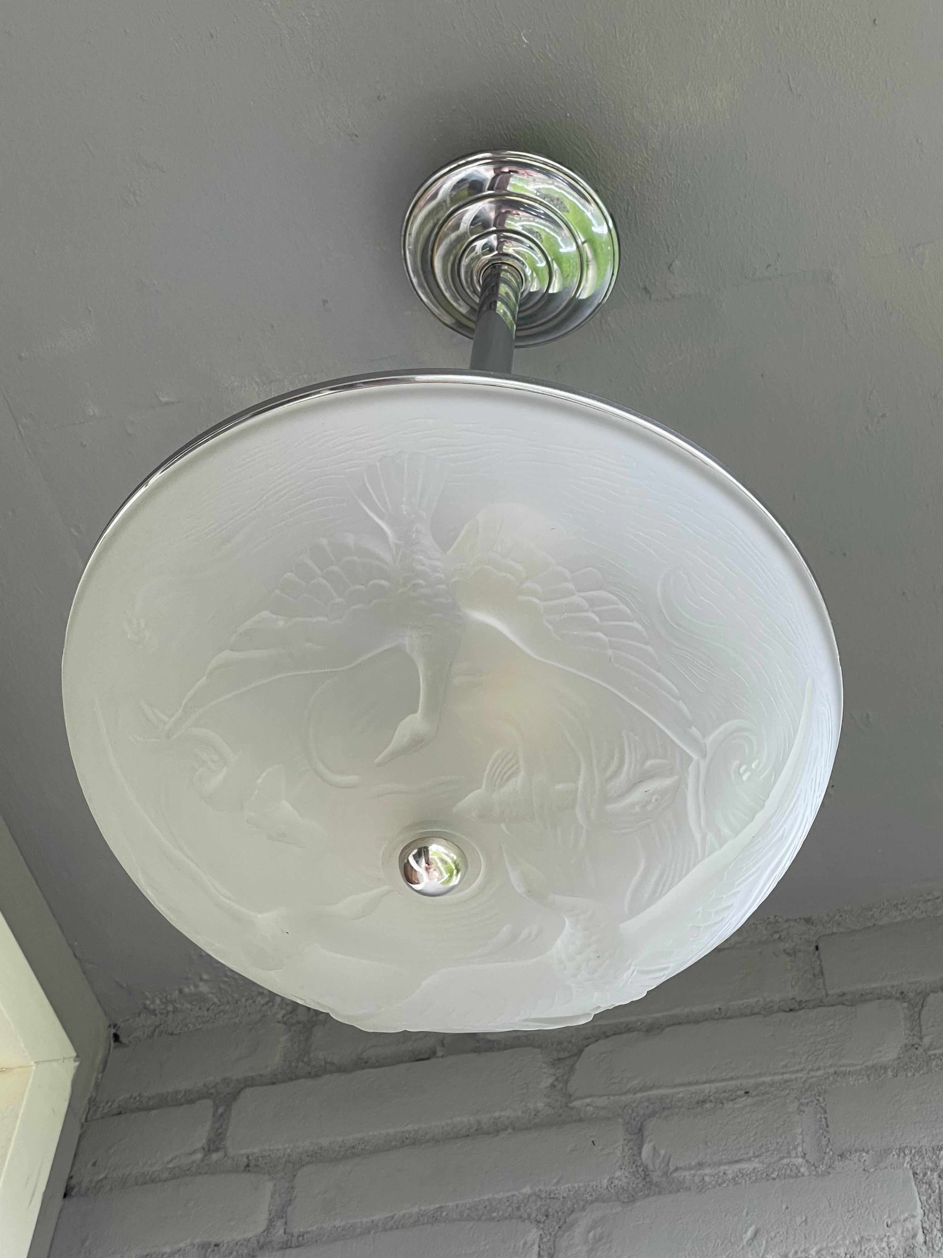Very stylish and rare, 1920s Art Deco chrome and art glass pendant light.

This early 20th century, French Art Deco light fixture is another great example of the stylish and meaningful pieces that the French were creating in the 1920s. The three