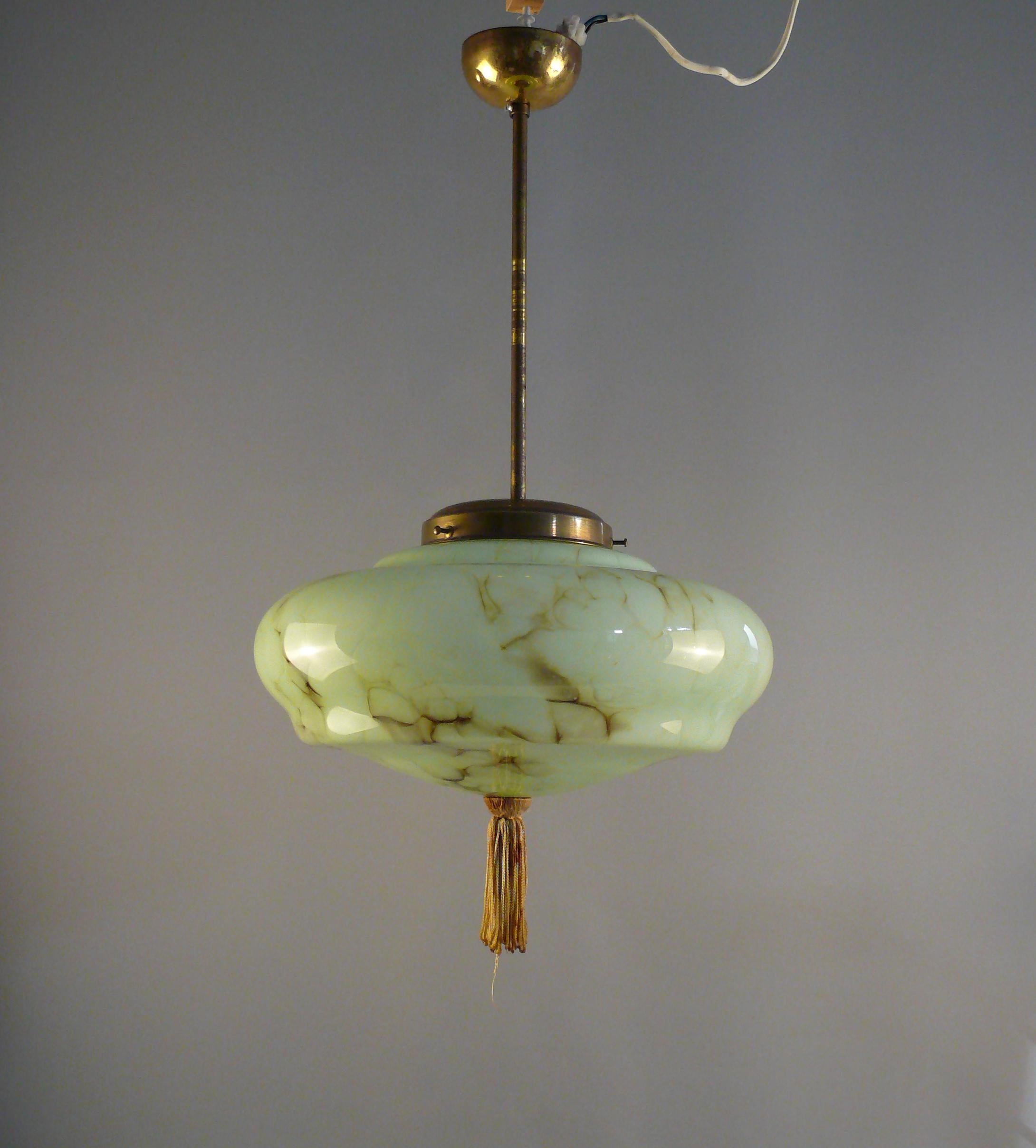 Art Deco rod pendant lamp from the 1930s - 1940s with a very beautiful, mint green glass shade. The glass shade has an elegant shape with subtle marbling and is in immaculate condition. The glass holder, the pendulum rod and the canopy are made of