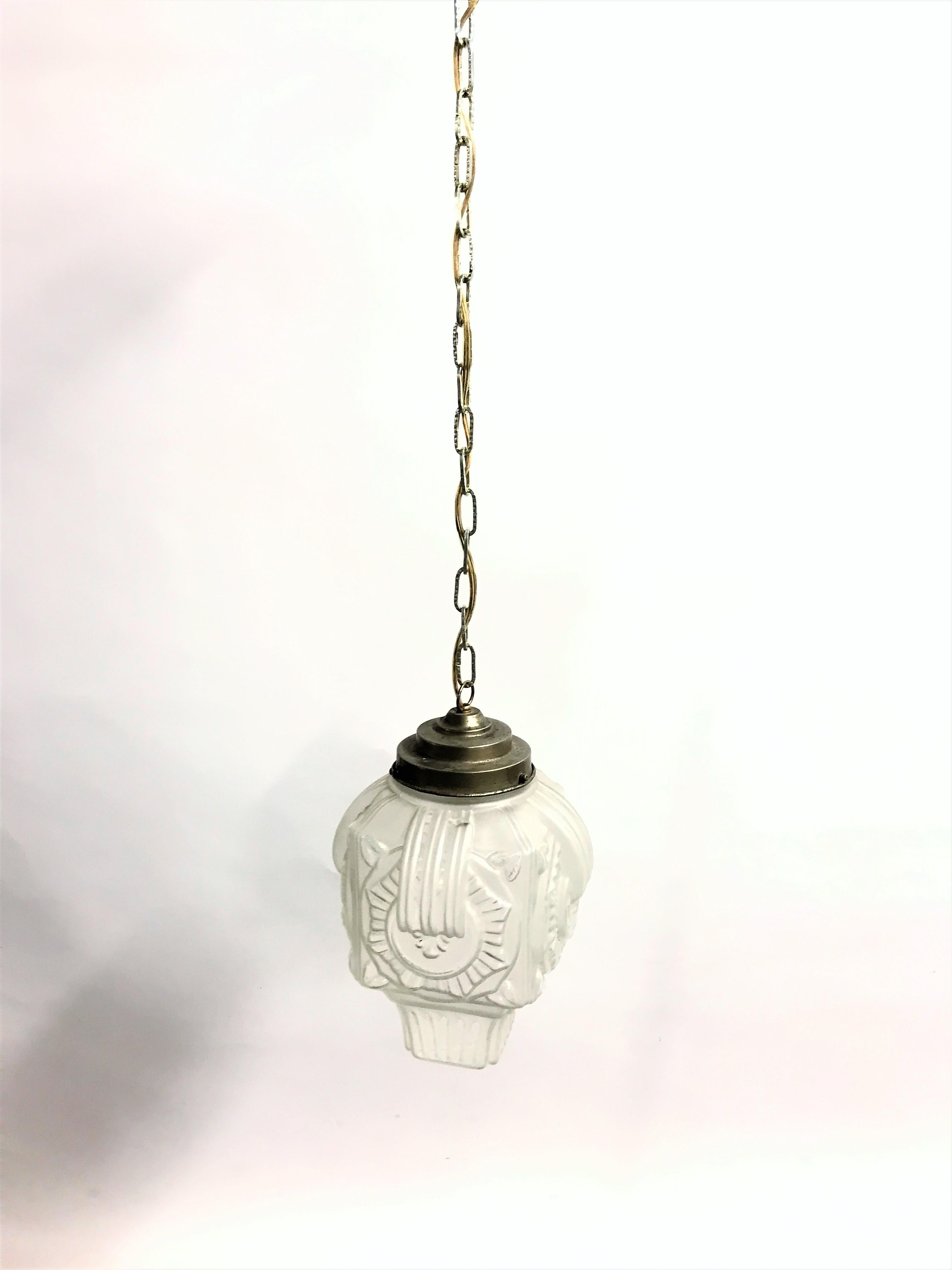 Antique art deco hallway pendant lights.

This glass design lamp is very typical for the art deco era and was widely used to be hung in hallways, offices or larger public places.

The lamp has the original stepped copper shade holder and ceiling