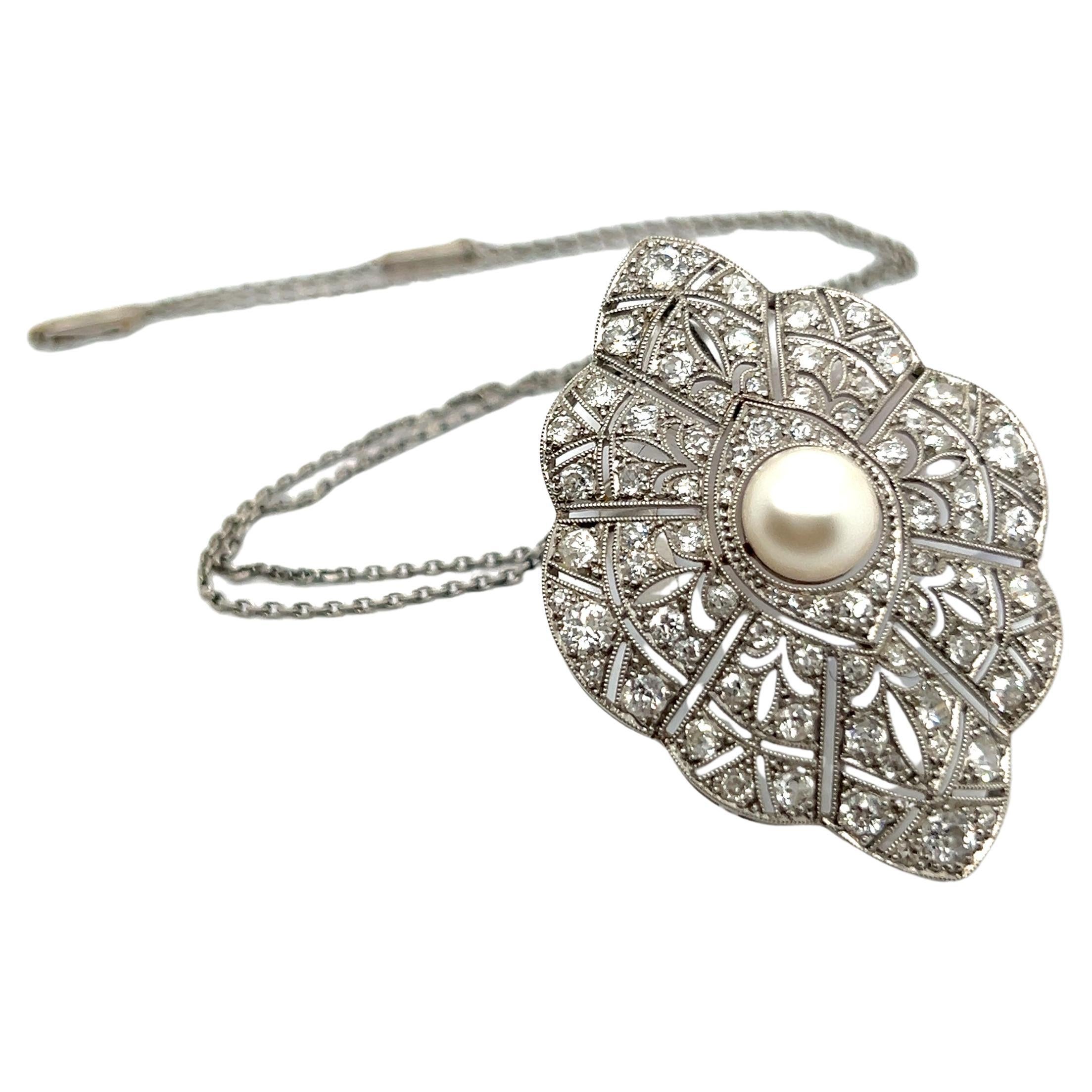 The pendant, an Art Deco masterpiece, is designed from fine platinum, intricately woven like a delicate, precious web. 

Adorned with 89 brilliant-cut diamonds, H-I in color and vs-si in clarity, totaling 2.80 carats, it glistens like dewdrops in