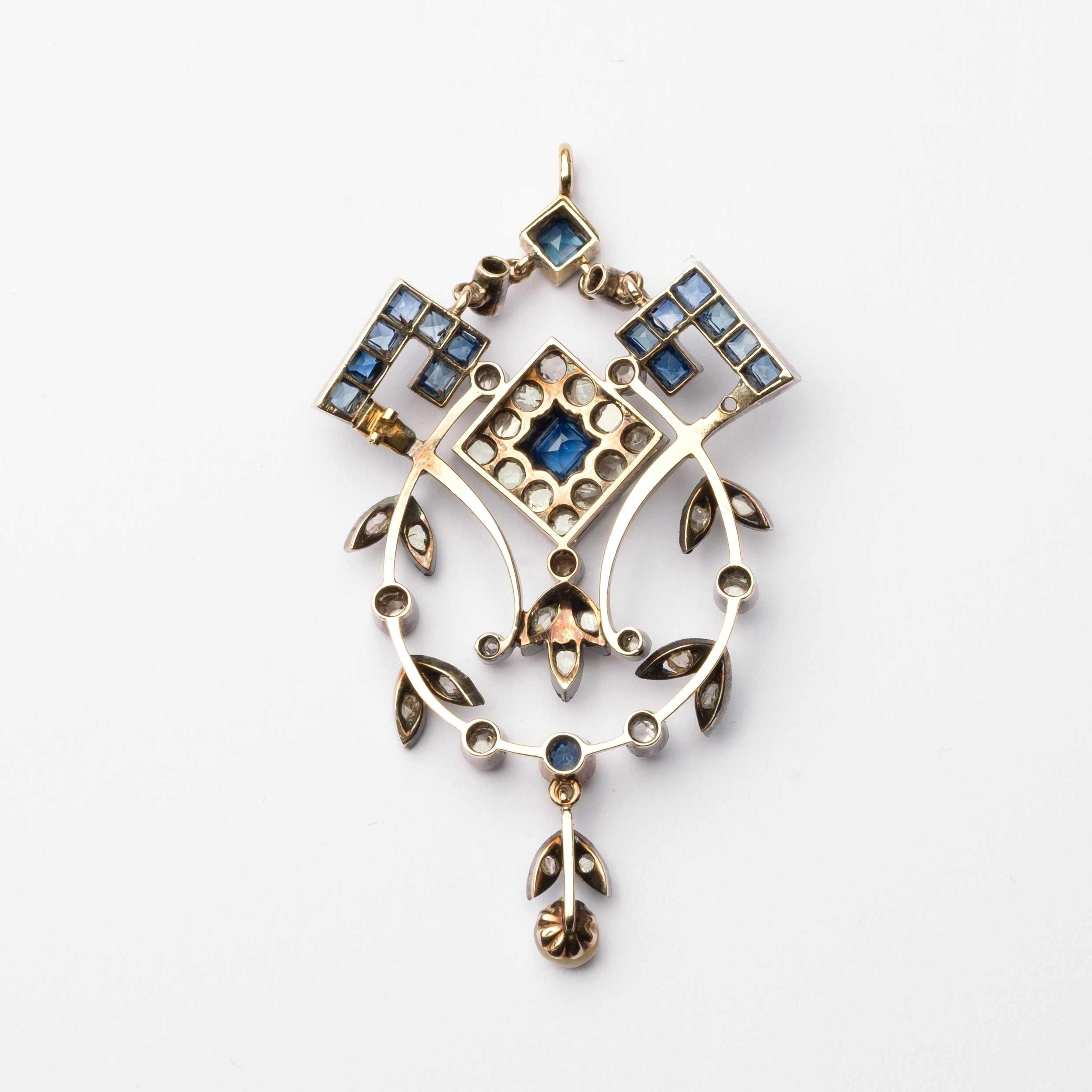 Beautiful deco period (1930s ca.) pendant set in gold and silver with rose cut diamonds and square cut sapphires.

Measurements: 5.5cm in length and 3.3cm in width
