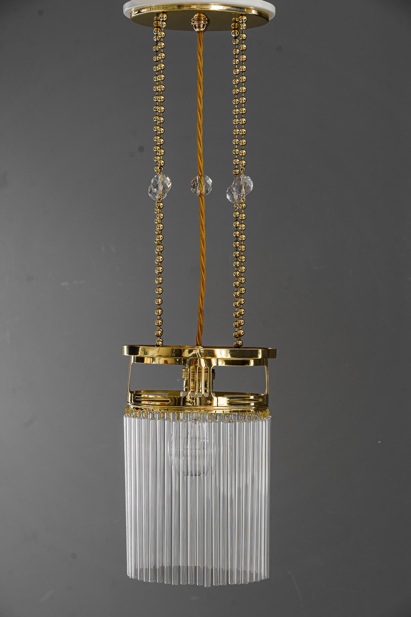 Art Deco pendant with glass sticks Vienna, around 1920s.
Brass polished and stove enameled.