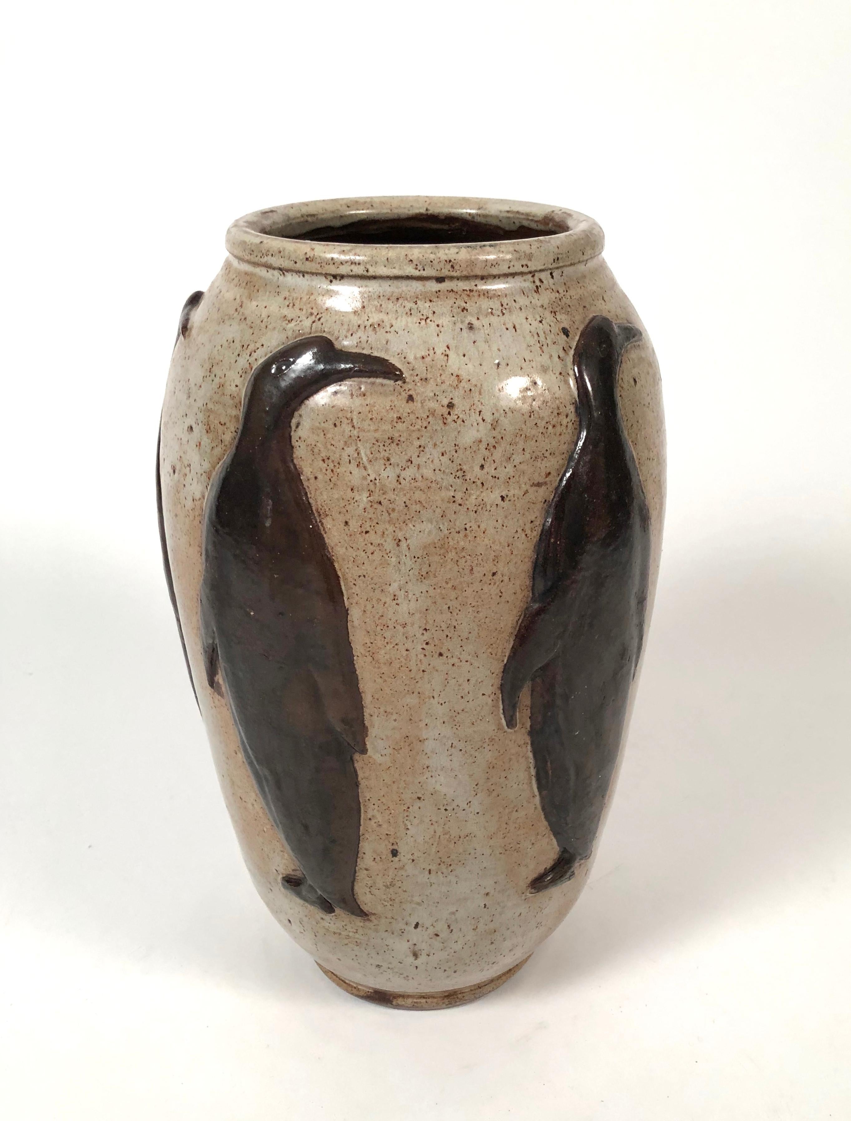 A handmade Art Deco Armogres stoneware art pottery vase, decorated with brown glazed penguins in relief on a speckled tan ground, in the manner of Roger Guerin, Bouffioulx, Belgium, circa 1930. Impressed stamp marks Bouffioulx and incised Armogres.