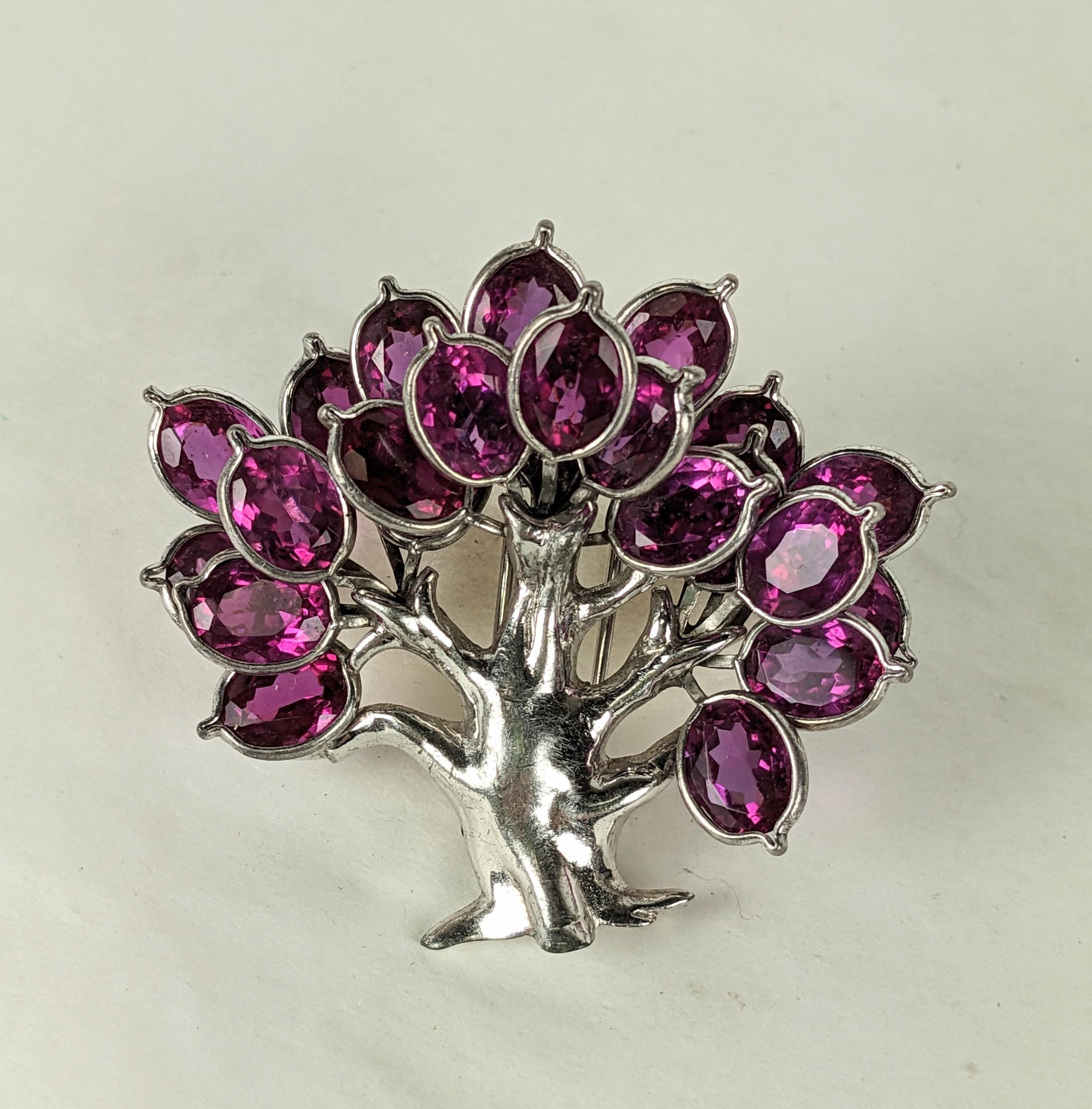 Rare Pennino Magenta Paste Clip brooch of oval collet set stones which forms the leaves in the tree. High rhodium finish from the Art Deco period. 1930's USA.  2.25