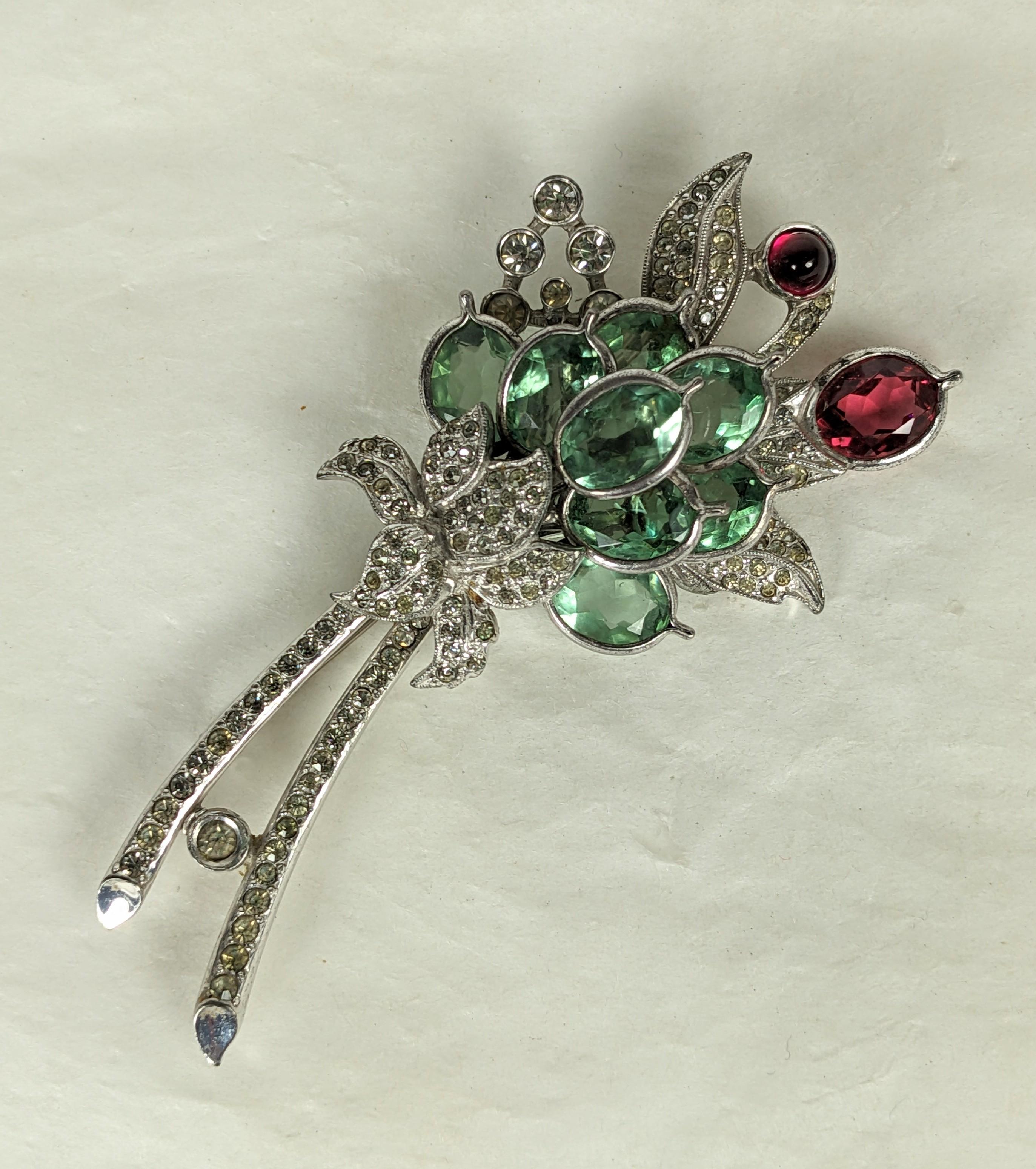 Lovely Art Deco Pennino Peridot and Ruby Paste Spray from the 1930's. Floral spray of bezel set pale green and ruby crystals set in intricate pave setting. 1930's USA. 3.25