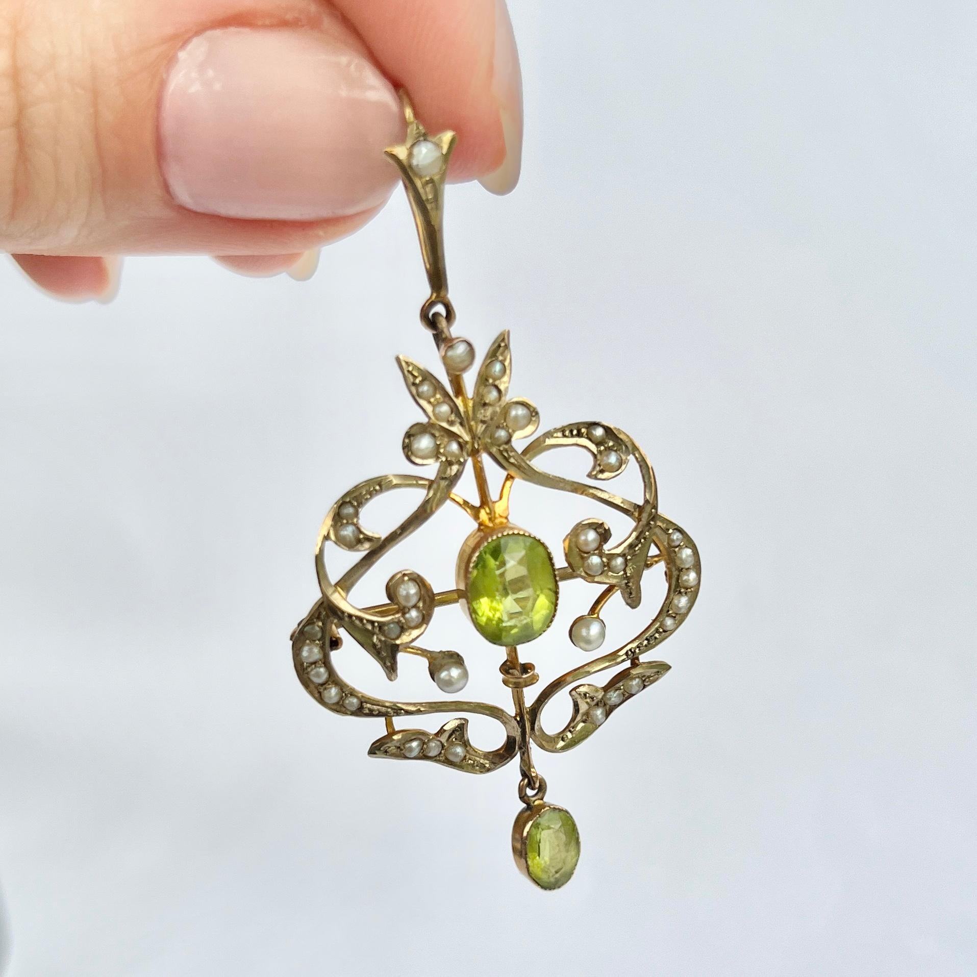 This pendant holds two peridot stones and is modelled in 9carat gold. The Pendant can also be a brooch and is decorated with seed pearls. 

Pendant top to bottom: 5.5cm

Weight: 3.8g