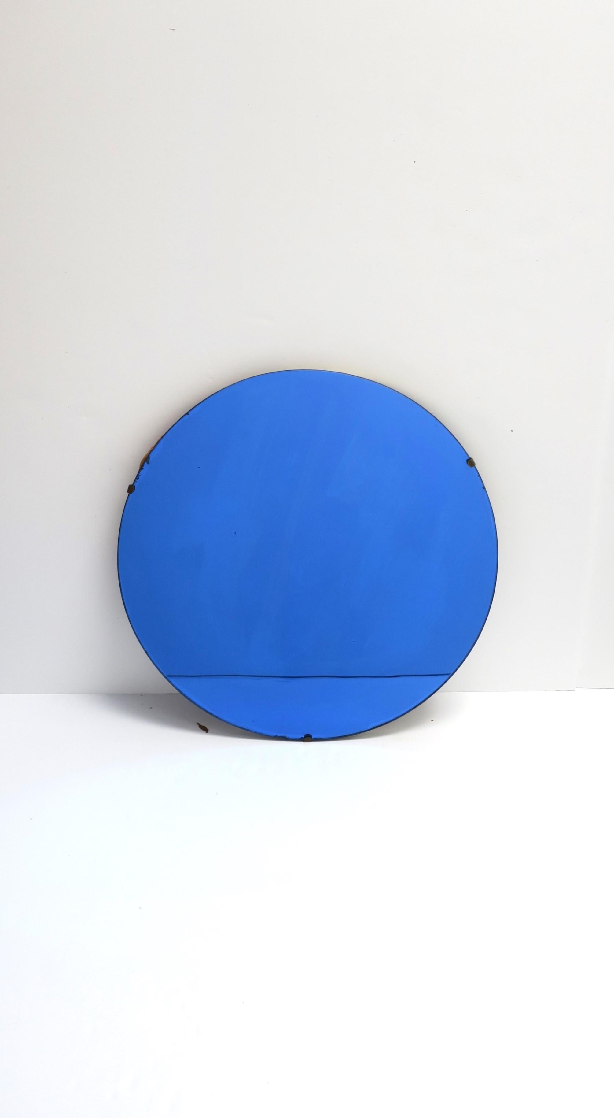 A beautiful cobalt blue round glass wall mirror, Art Deco period, circa early-20th century, Europe. Piece is prepared for hanging as shown in last image. Very good condition as shown in images. No chips noted. Dimensions: .88