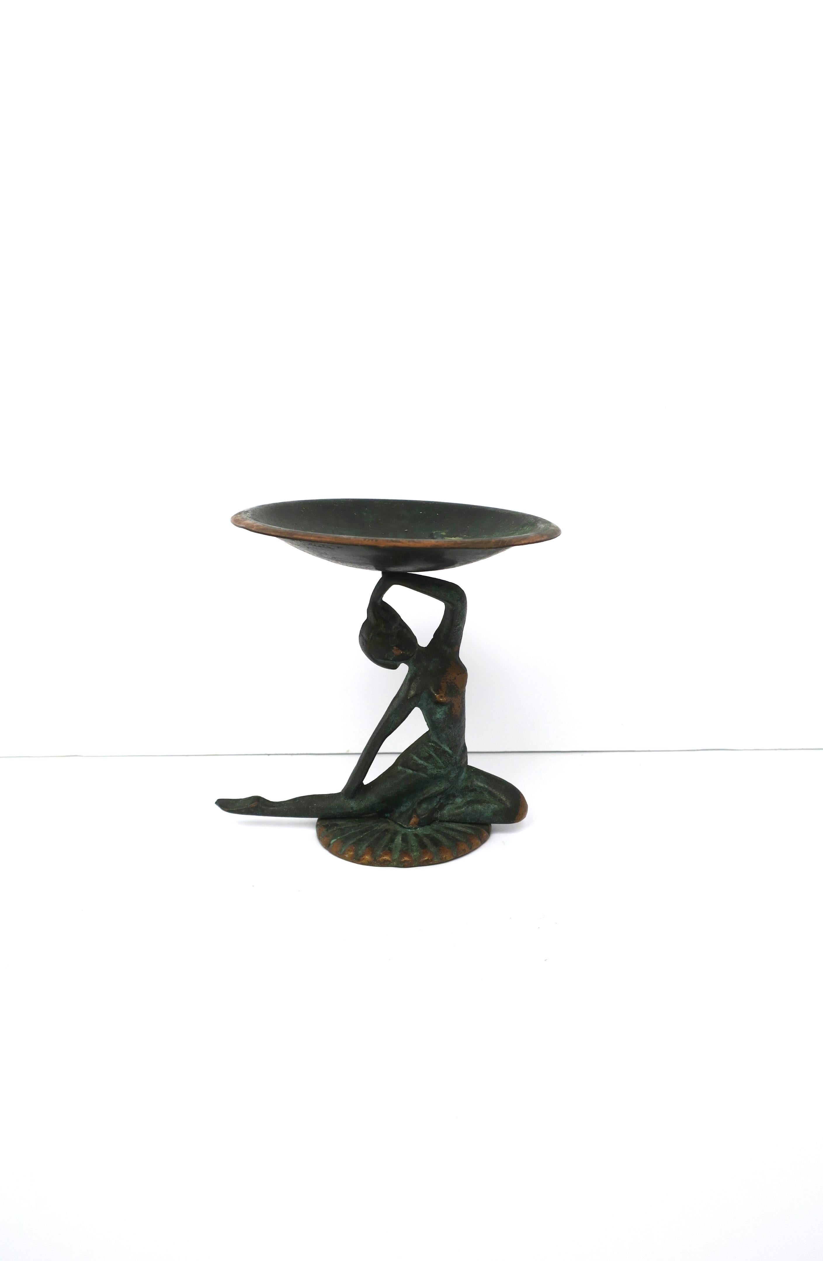 A bronze/brass and copper Art Deco period tazza coupe compote with female figurative design, circa early-20th century, Europe. Piece has a verdigris green finish over its copper and bronze makeup. Coup is copper with a verdigris green finish, and