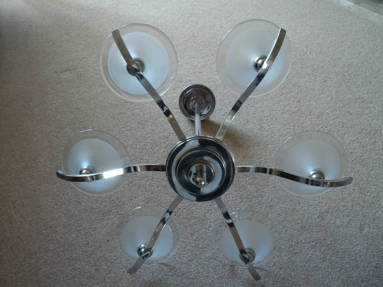 This is a substantial, hanging ceiling light, lamp or chandelier with six branches and beautiful glass conical shades, original to the Art Deco period.

The light is made from chromed metal possibly brass.

It has a central vertical tubular rod
