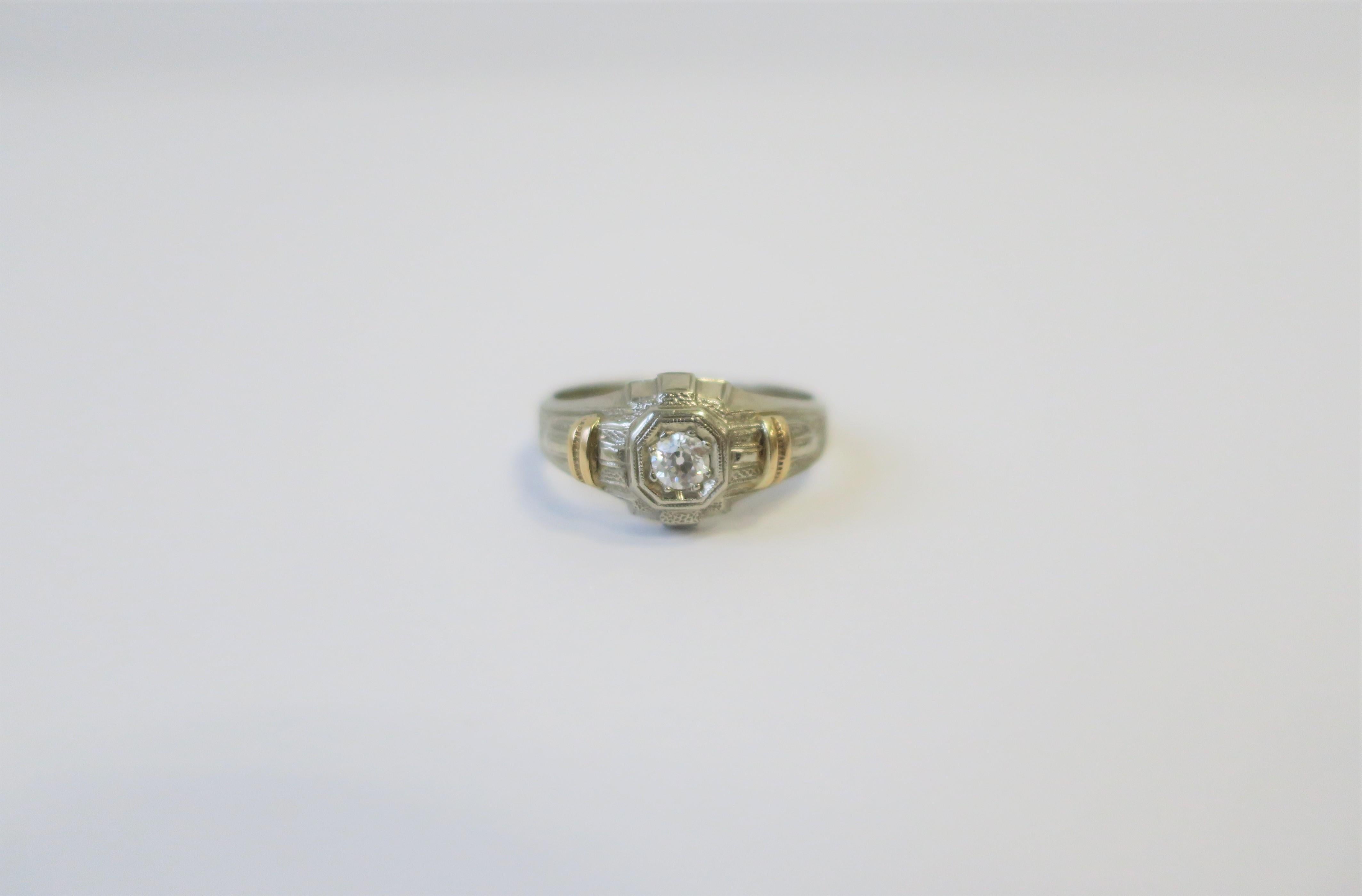 A beautiful Art Deco era/period diamond and 14-karat white & yellow gold men's ring, circa early 20th century, 1930s. Ring is a size 8.5, which can be adjusted by a professional jeweler. Diamond is a solitaire/round cut with beautiful clarity and