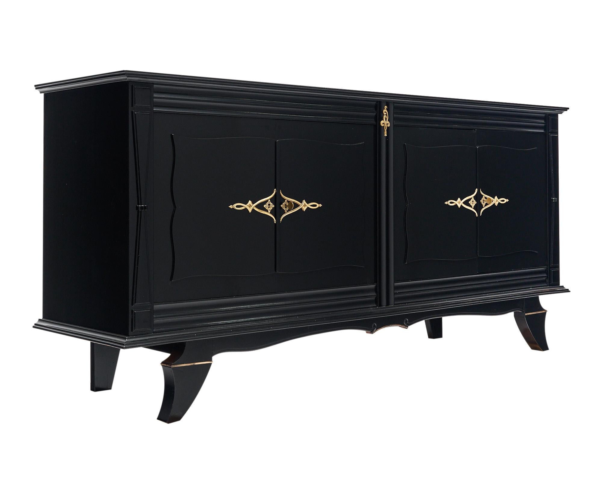 Buffet from the Art Deco period in France. This piece has been finished in an ebonized French polish providing a Museum quality luster. There are two set of doors that open outward to reveal interior shelving and a single dovetailed drawer. The