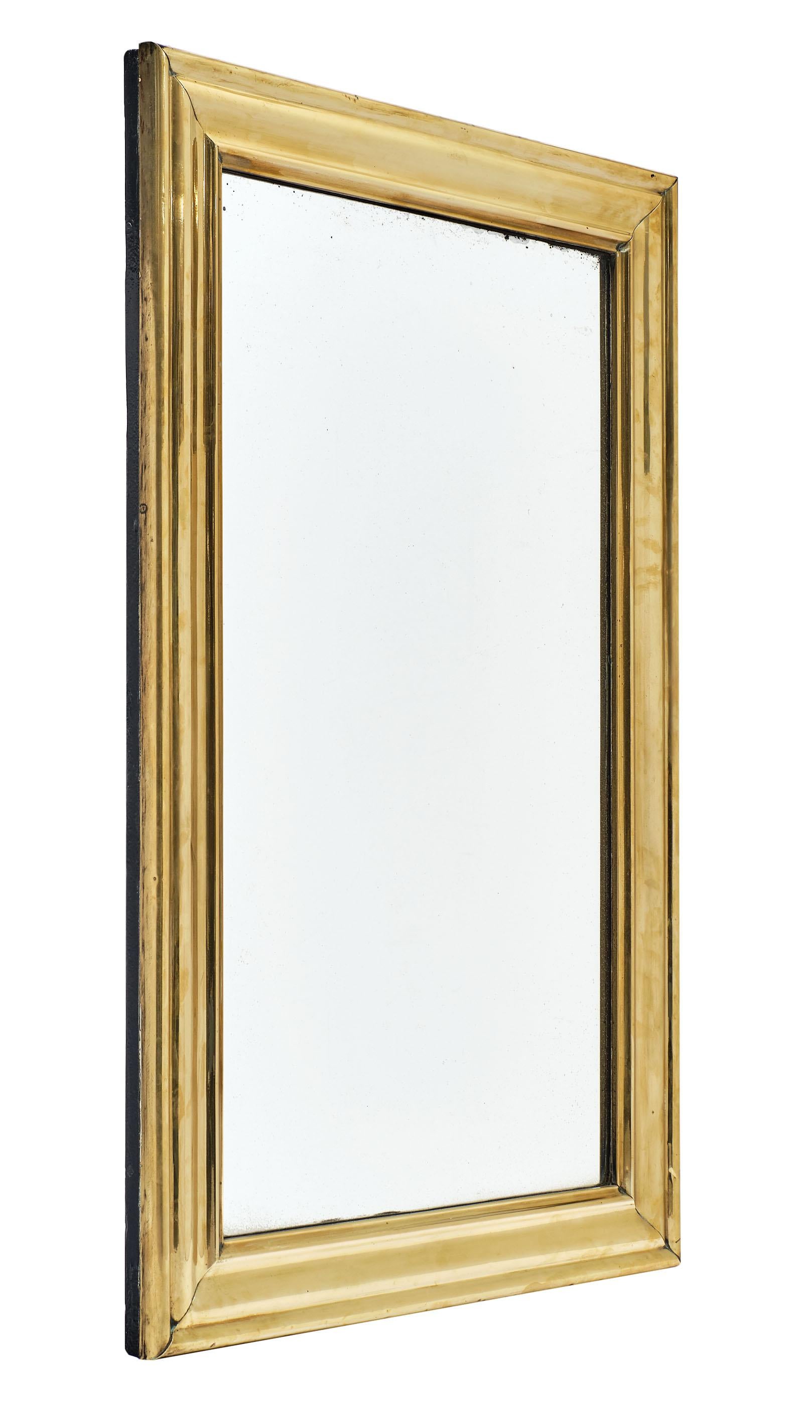 French Napoleon III gilt brass mirror with the original glass. We love the impressive size and style of this piece!