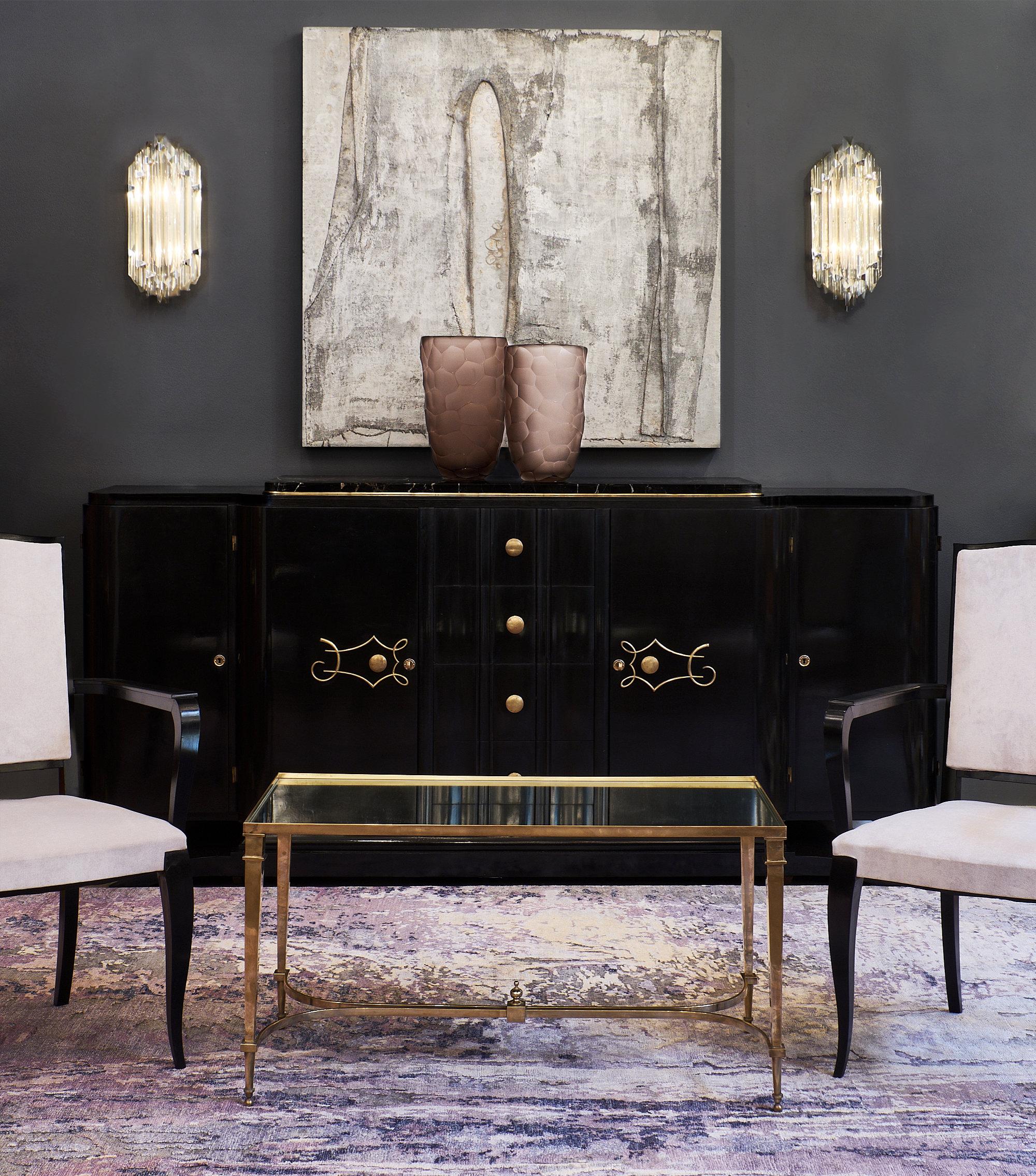 A fine French Art Deco period buffet or enfilade made of mahogany, ebonized and finished in a lustrous French polish. This piece is in mint restored condition with the unique and intact “Portor” marble slab. This elegant credenza features two doors