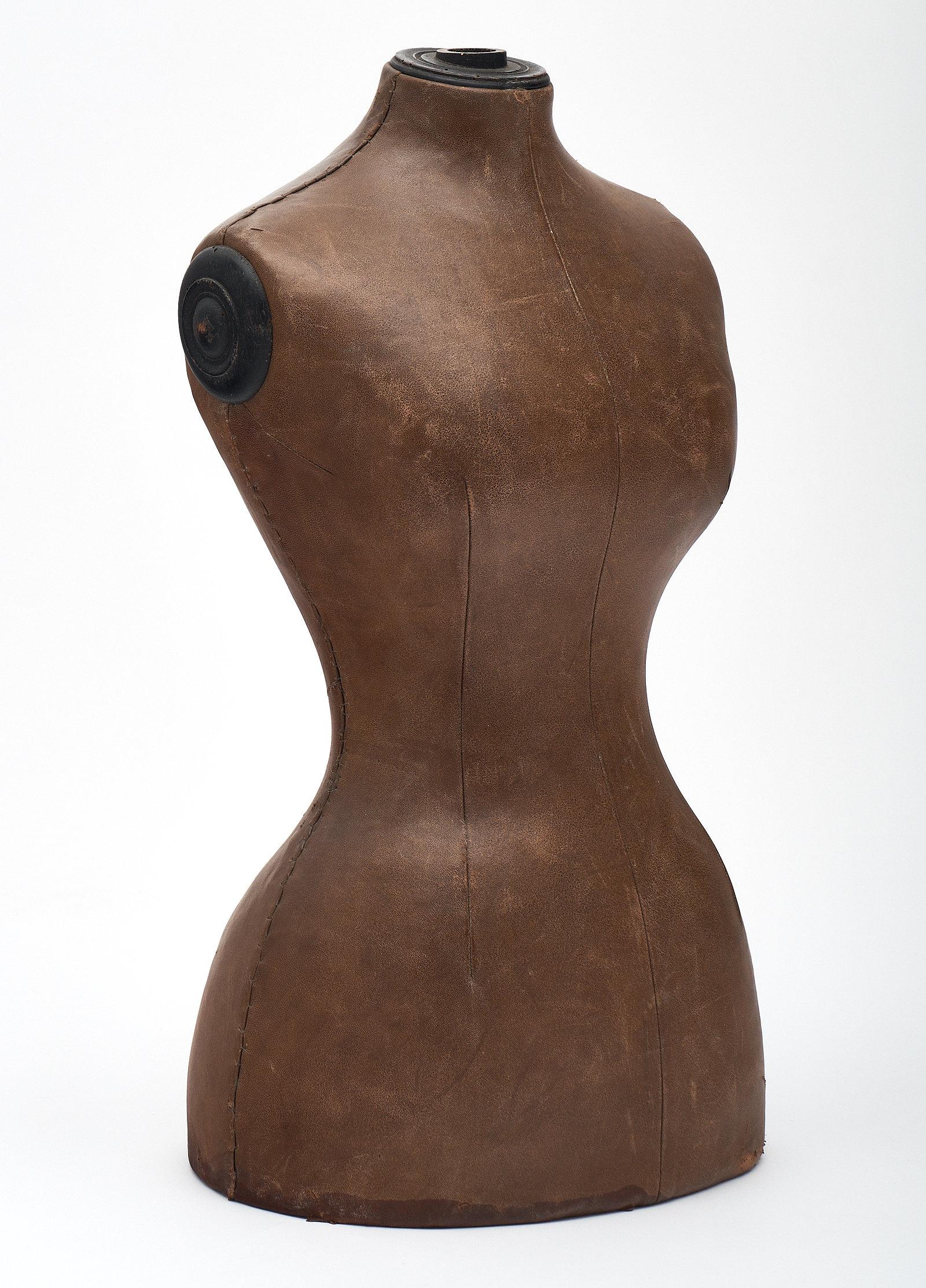 Art Deco period French couture mannequin made of wood and waxed canvas. The curved silhouette is beautiful and feminine, while the patina on the canvas offers a slightly masculine balance.